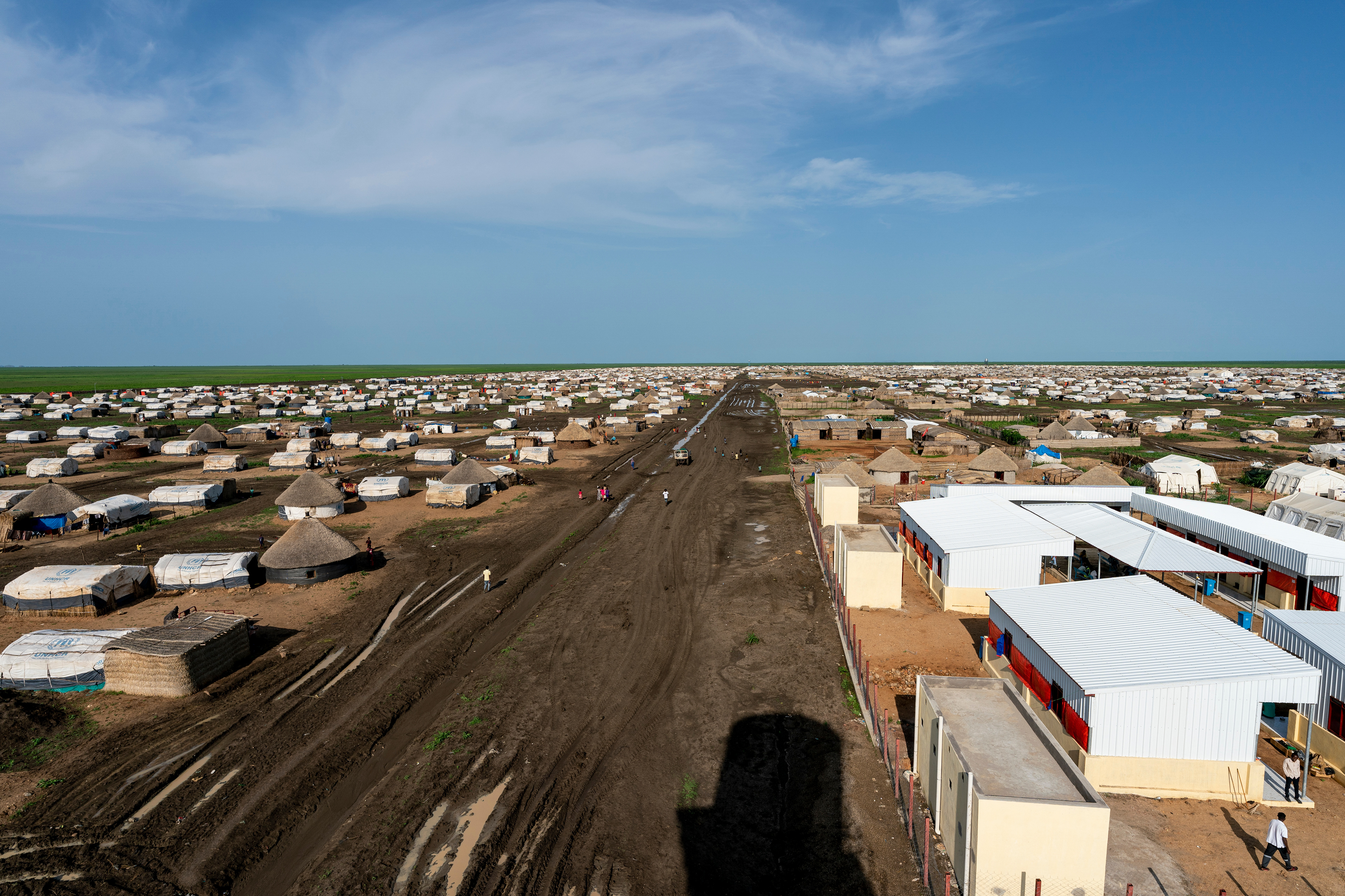 A mud-filled street separates two of twelve settlement blocks Tuneidba Refugee Camp near Gedaref, Sudan, as seen from atop a not yet functional water tower.