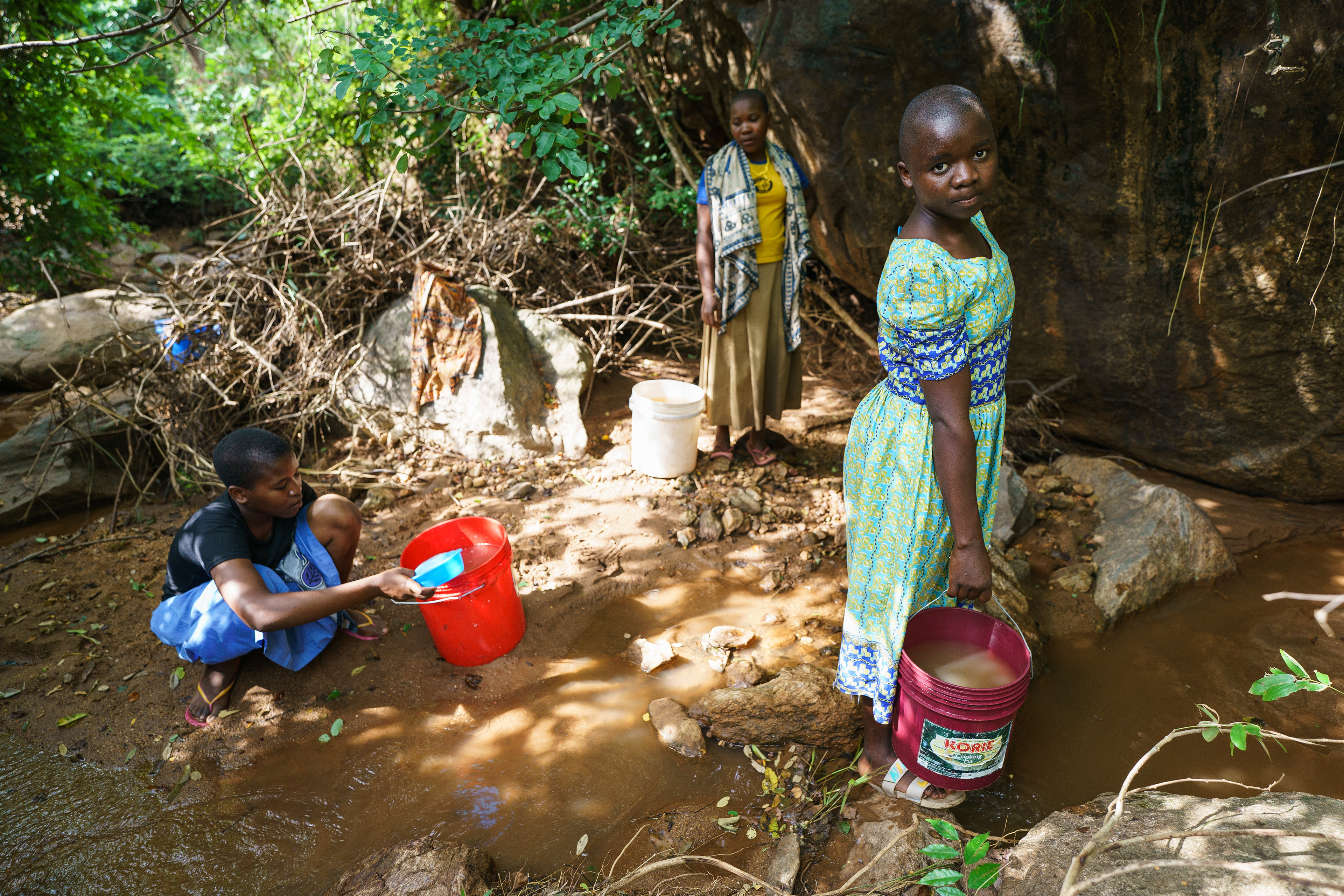 Berta Leonard, 17, collects water from a nearby stream with a group of girls from her school in Romero, Tanzania.  Only 500 meters from the school, the stream only has water during the spring rainy season.