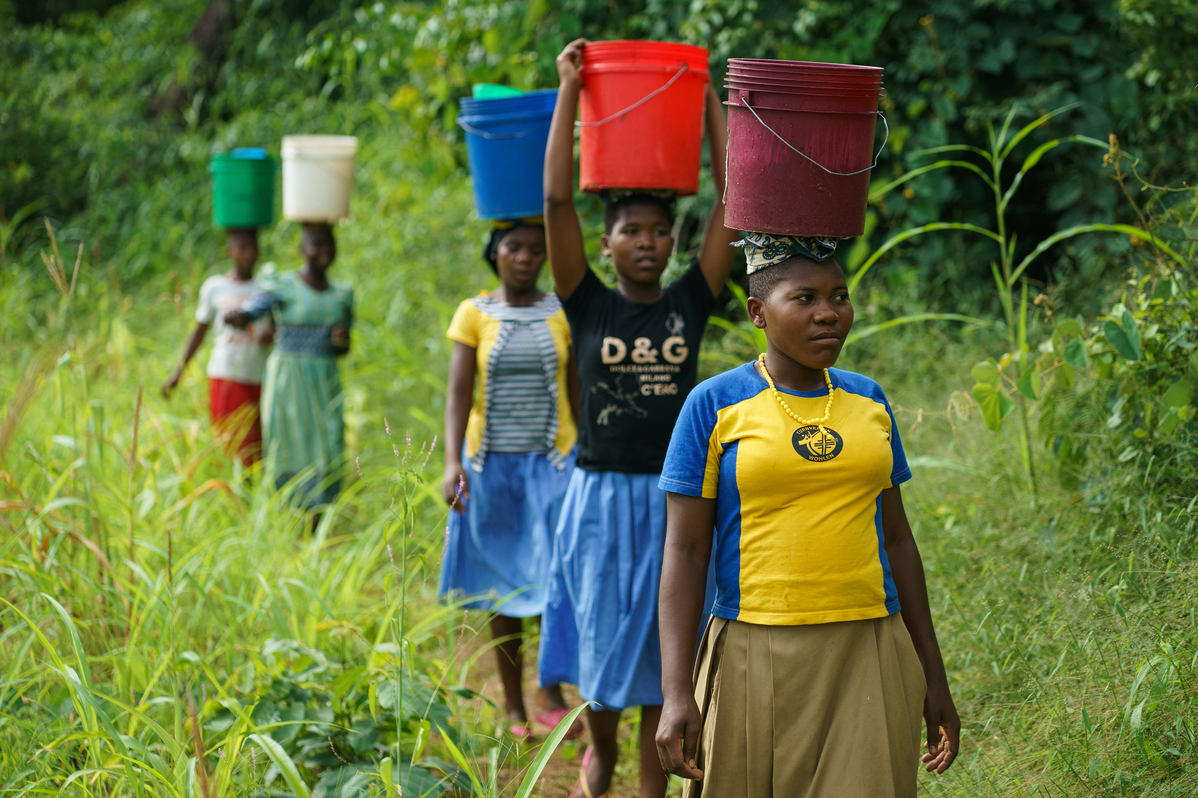 Girls collect water for their school in Mvomero, Tanzania, at a nearby stream.