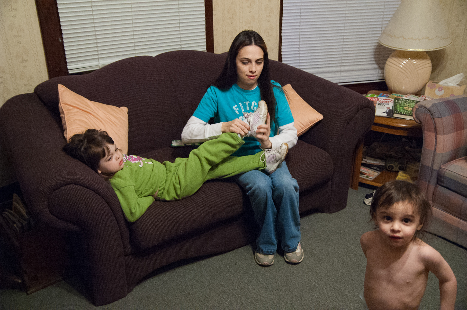 Amanda readies Kylie for the day as Avery looks on. Amanda will spend her day at the Warren County One Stop training center in GED preparation classes while the children will go to day care and Head Start.