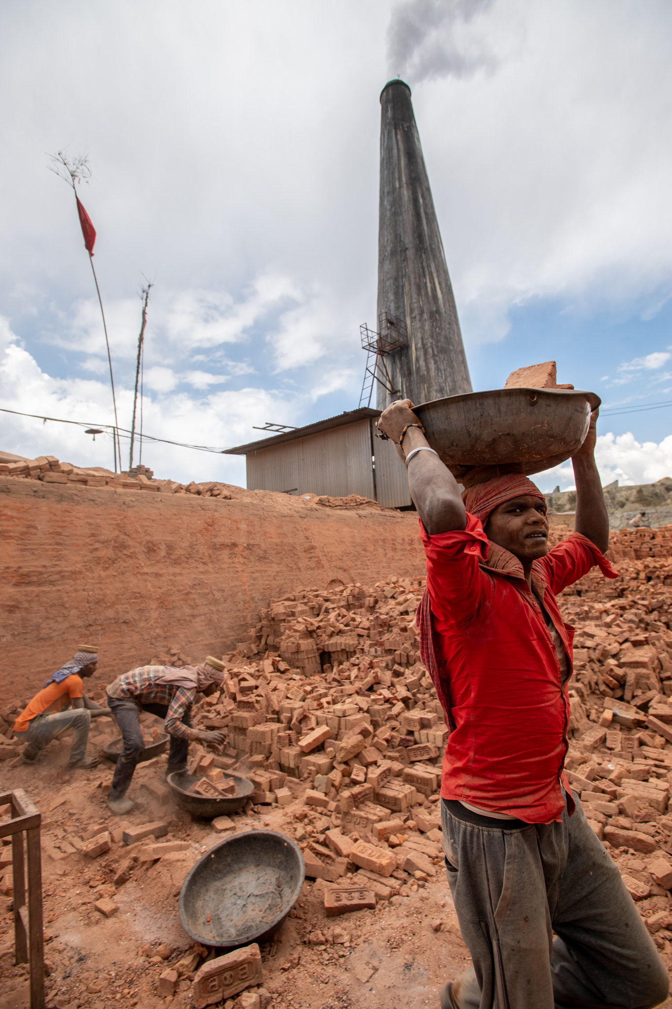 Still warm broken bricks from a recent kiln burn are hauled away.