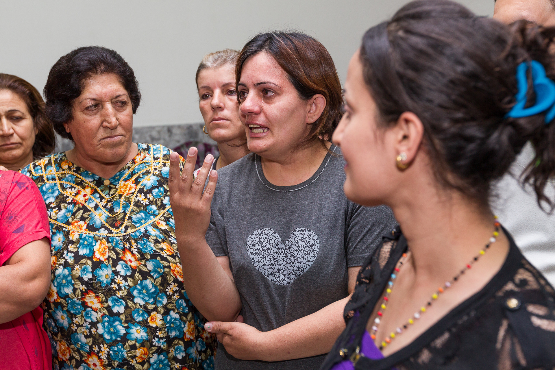 A woman who has taken refuge at St. Peter and Paul Ancient Assyrian Church of the East in Dohuk, pleads for help to return to her home from the delegation of WCC visitors. Sixty families displaced from their homes by ISIS forces have been offered refuge on the church grounds, living in the parish hall and educational rooms. 