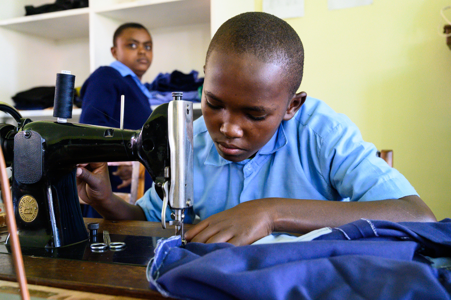 A tailoring student at work.
