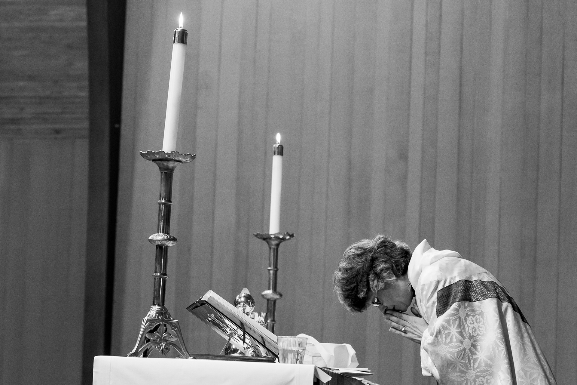 Rev. Sara Fischer prays prior to communion during high mass at St. David of Wales Episcopal Church in Portland, Ore.