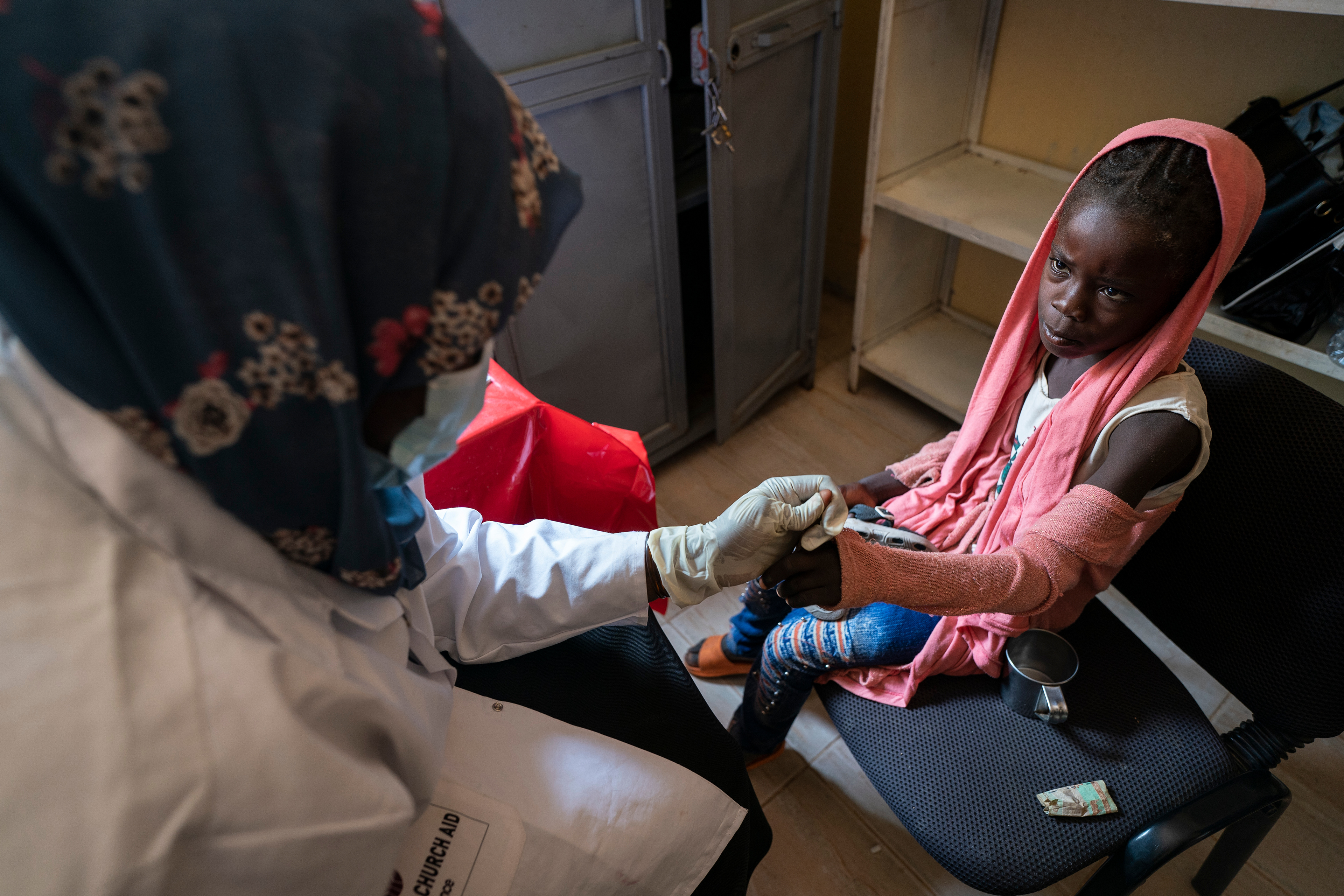A nurse conducts a blood-drop malaria test at the health clinic at the Beliel Camp for internally displaced persons near Nyala, South Darfur, Sudan.