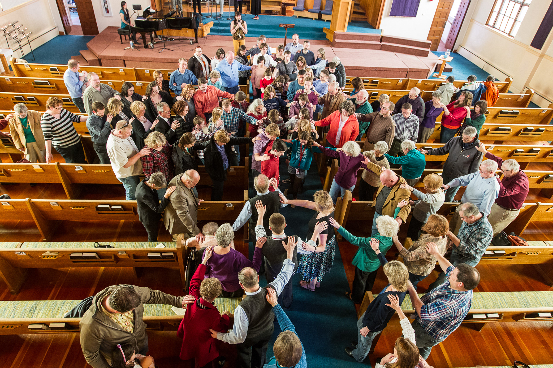Congregation members gather around Y.A.H.O.O. (Yamhill Alliance Helping Others Out) Mexico mission members for a blessing prior to their departure.