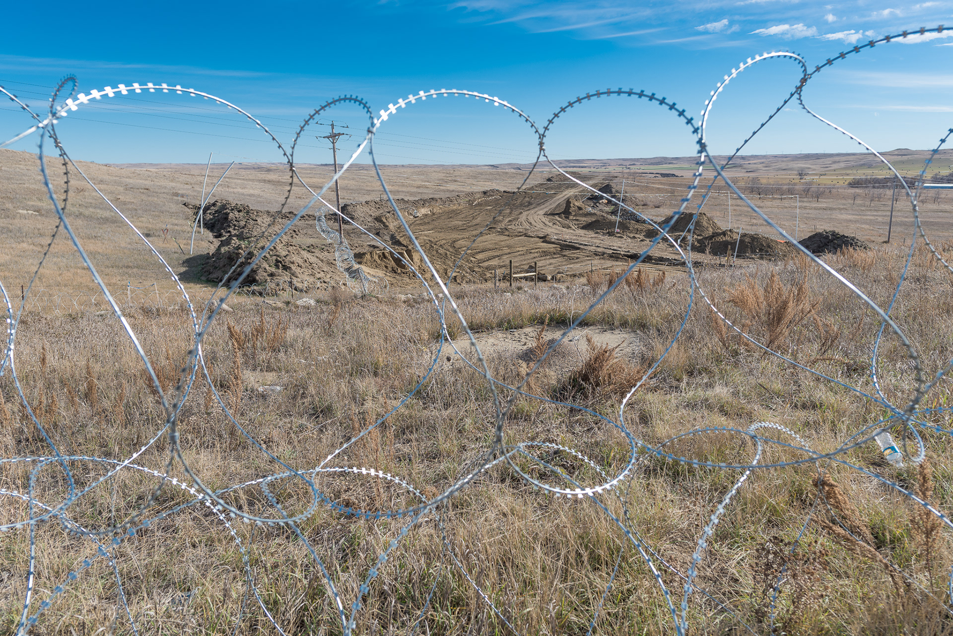 Barbed wire protects the construction area of the Dakota Access Pipeline as it snakes its way east toward the Missouri River and the site of Standing Rock protests.