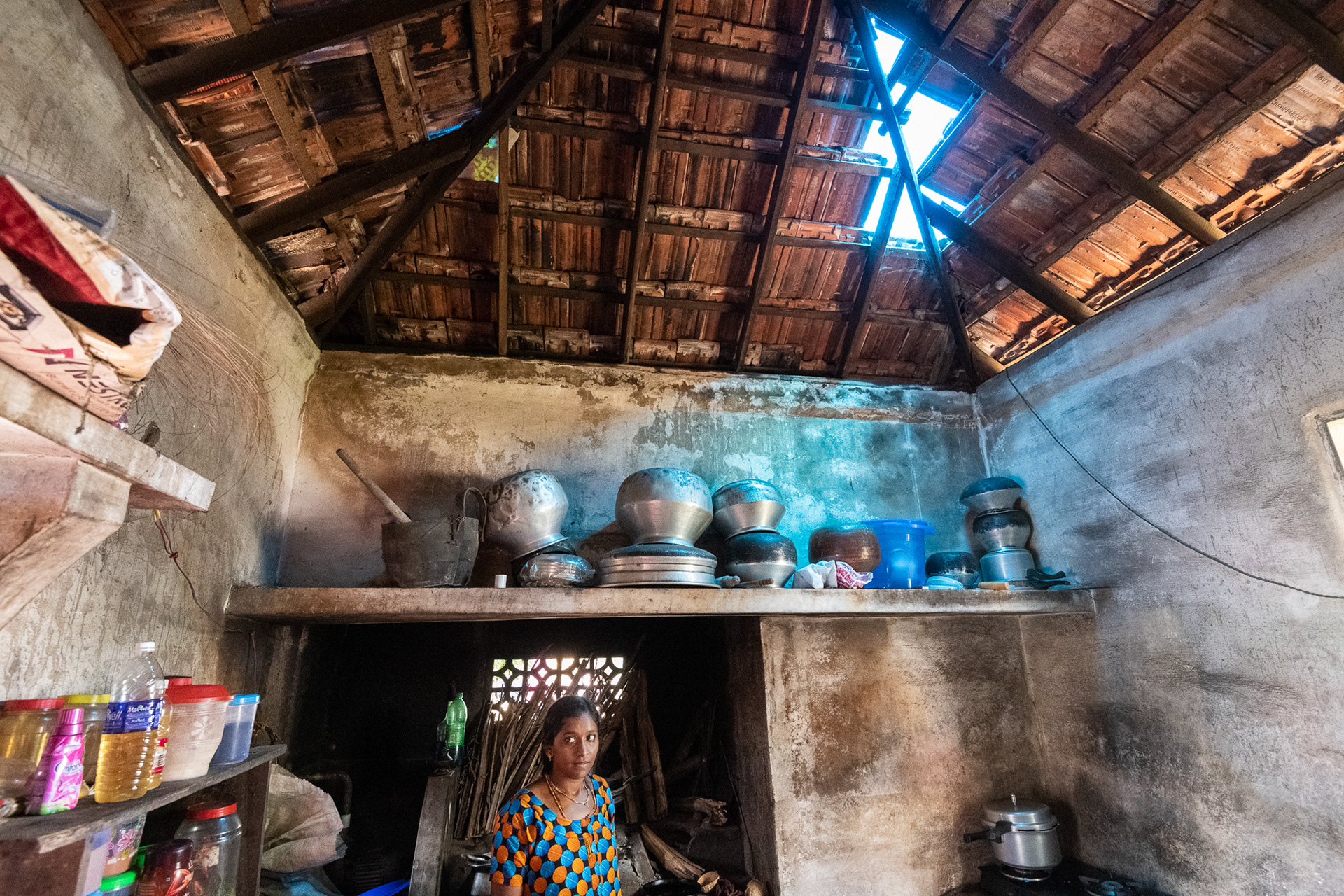 A woman prepares a meal in a kitchen with extensive structural damage following the August 14-18, 2018 flooding that struck Kerala, India. ACT Alliance partner Christian Agency for Rural Development (CARD) is assisting Miriam and others in this Dalit colony near Thiruvallla.