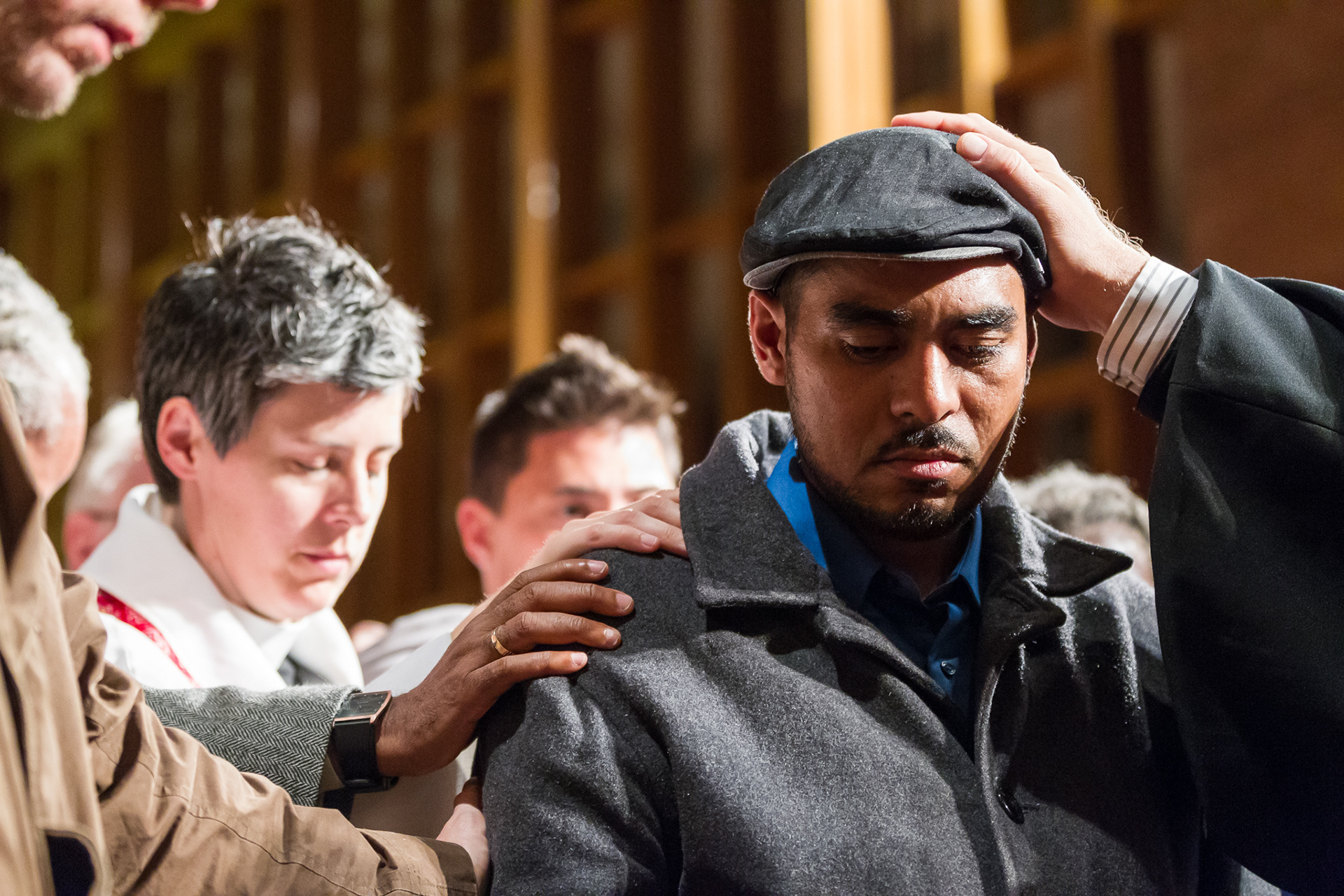 The Rev. Chris Craun, rector of St. Michaels and All Angels Episcopal Church in Portland, Ore., prays with Francisco Aguirre at the "This is Where I Belong" community rally held at Augustana Lutheran Church. The September 30, 2014, rally was in support of Aguirre who has taken sanctuary in the church following threat of deportation by ICE officials. Aguirre has lived undocumented in Portland for 19 years and is a leader in the immigrants rights community.