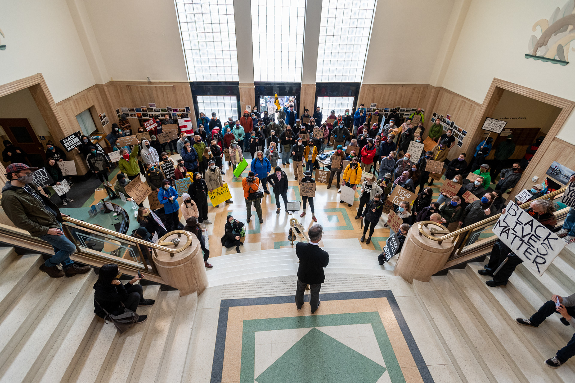 Protesters in the rotunda of Bellingham City Hall ask Mayor Seth Fleetwood about his plans for police reform and community resource allocation at a June 15, 2020 protest.