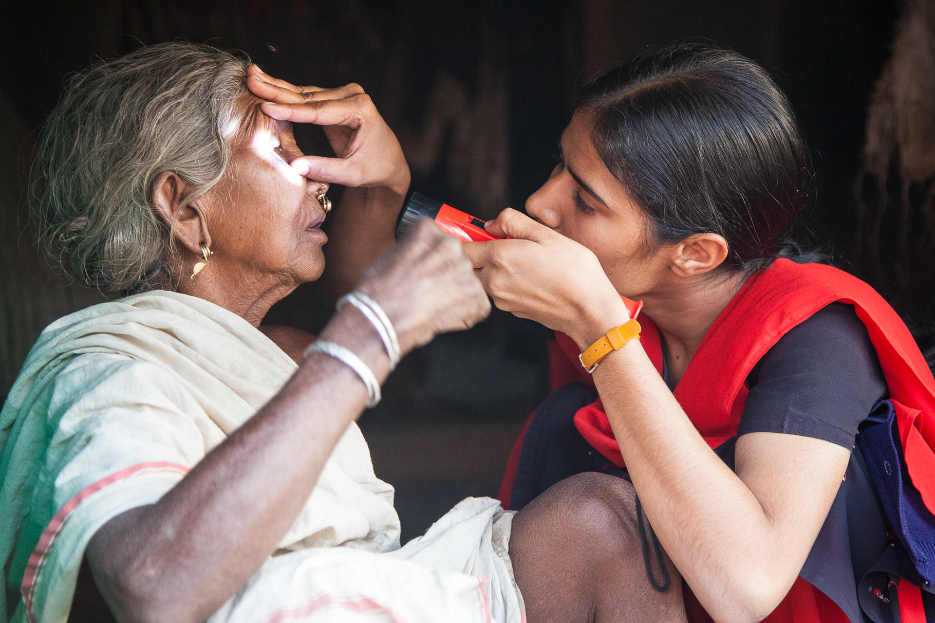 A nurse from the Christian Hosptial, Bissamcuttack , India, checks a woman's eyes.