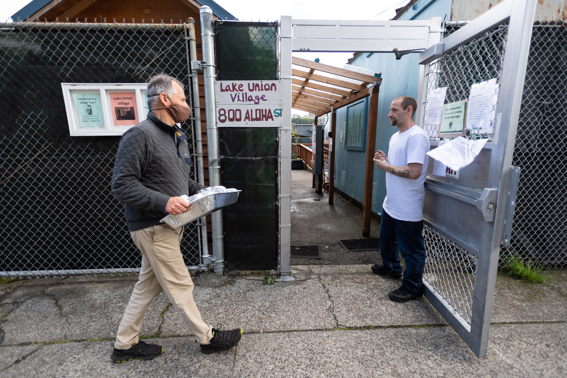 The Rev. James B. Notkin delivers prepared burritos to the Lake Union Village tiny house encampment located near Union Church Seattle.