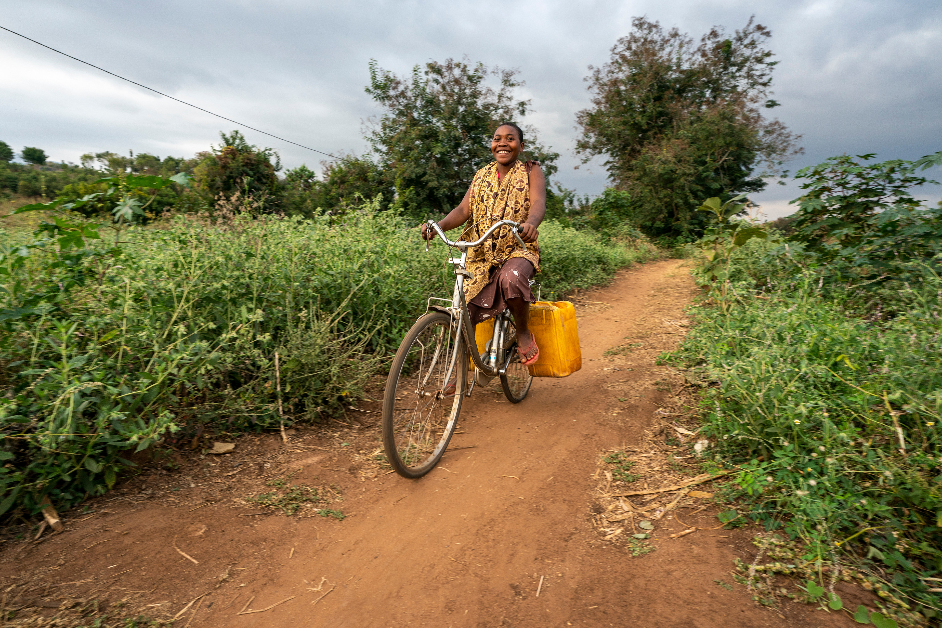 A resident at EMFERD (The Eric Memorial Foundation for the Education and Rehabilitation of the Disabled) orphanage in Mvomero, Tanzania, fetches water via bicycle.