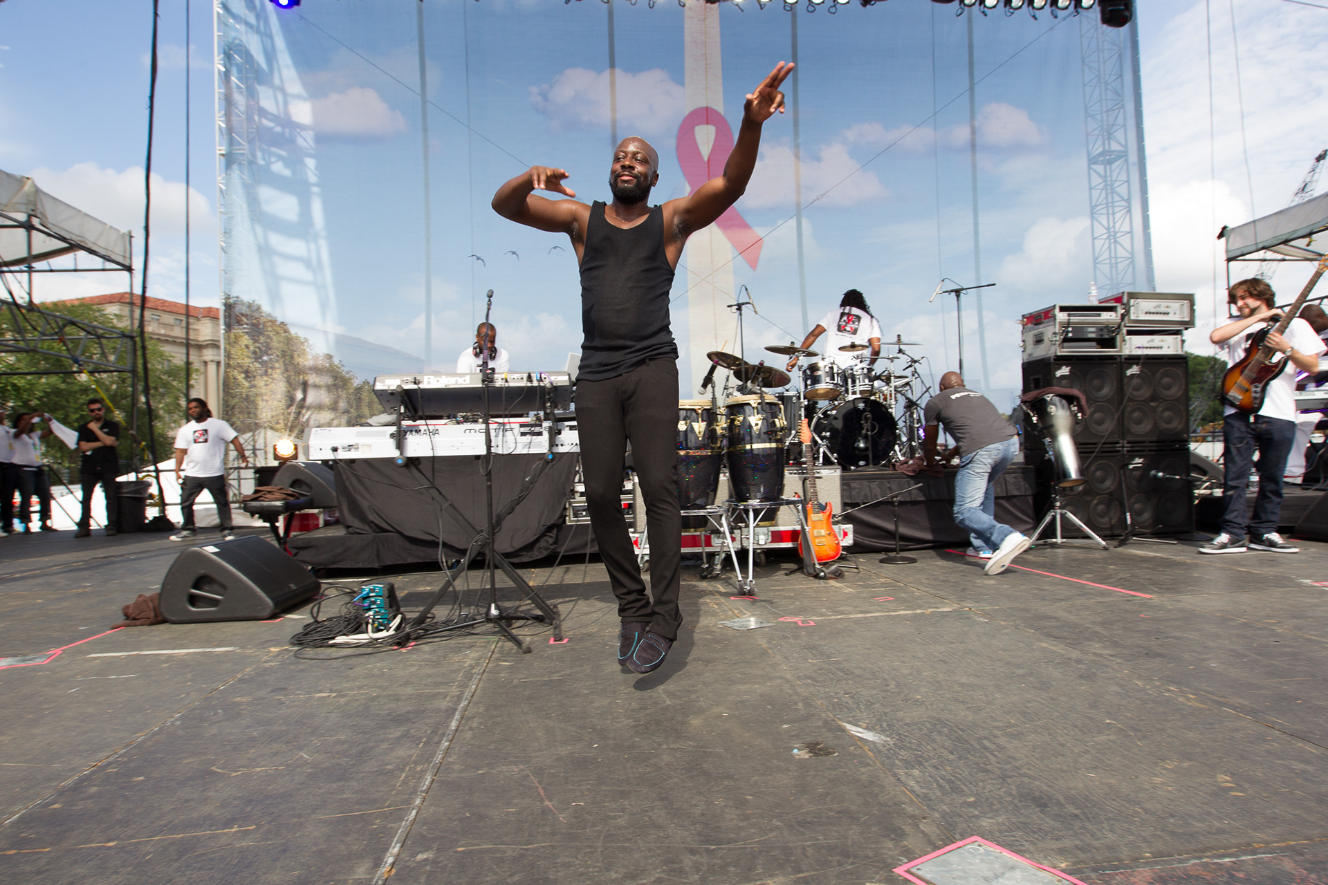 Wycliff Jean leaps as he prepares to leave the stage following his July 22, 2012, concert during a rally as part of the International AIDS Conference.