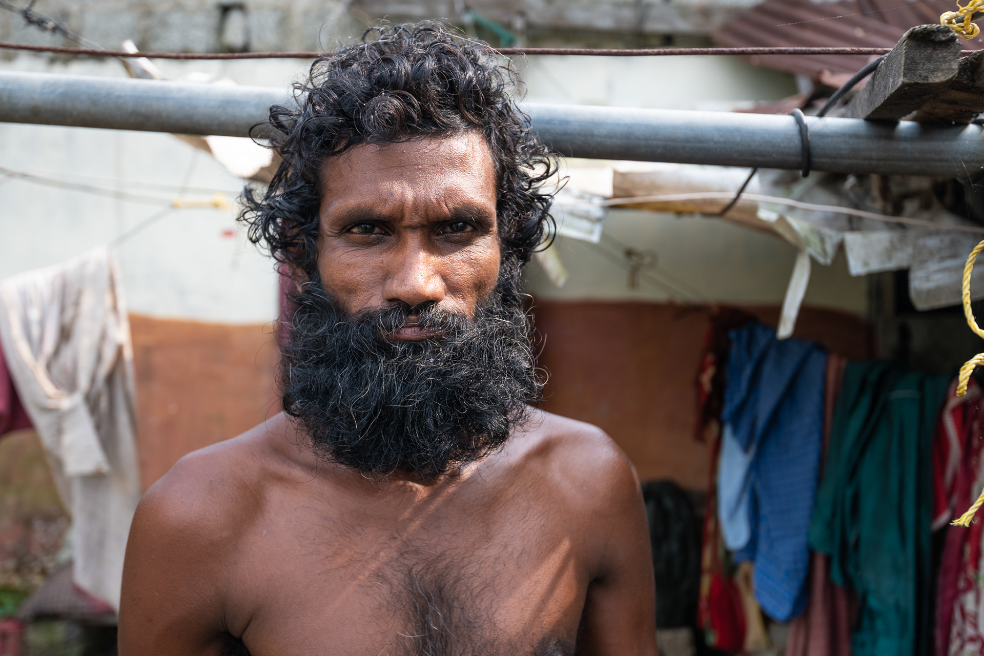 Dibu Sridher stands outside his home destroyed by the August 14-18, 2018 flooding that struck Kerala, India. ACT Alliance partner Christian Agency for Rural Development (CARD) is providing assistance in this Dalit colony near Thiruvallla. 