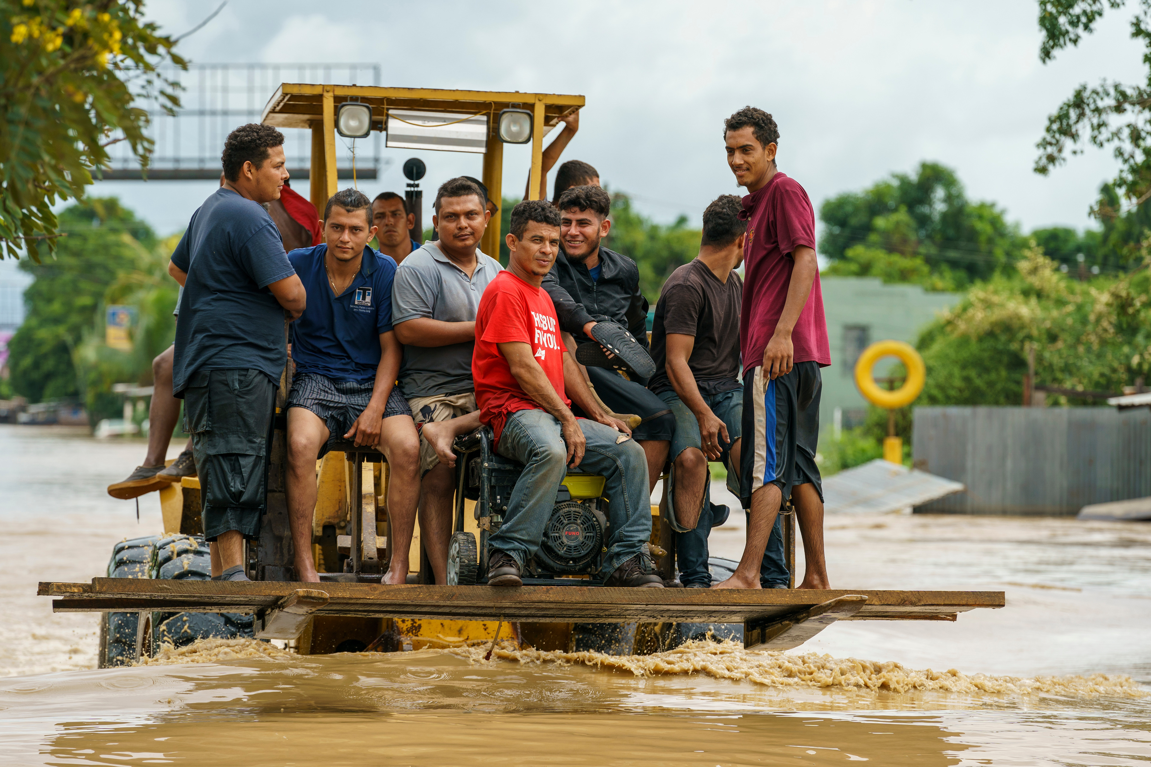 A tractor transports evacuees through rushing water in Jerusalen, Honduras, following flooding from Hurricane Iota in November 2020.