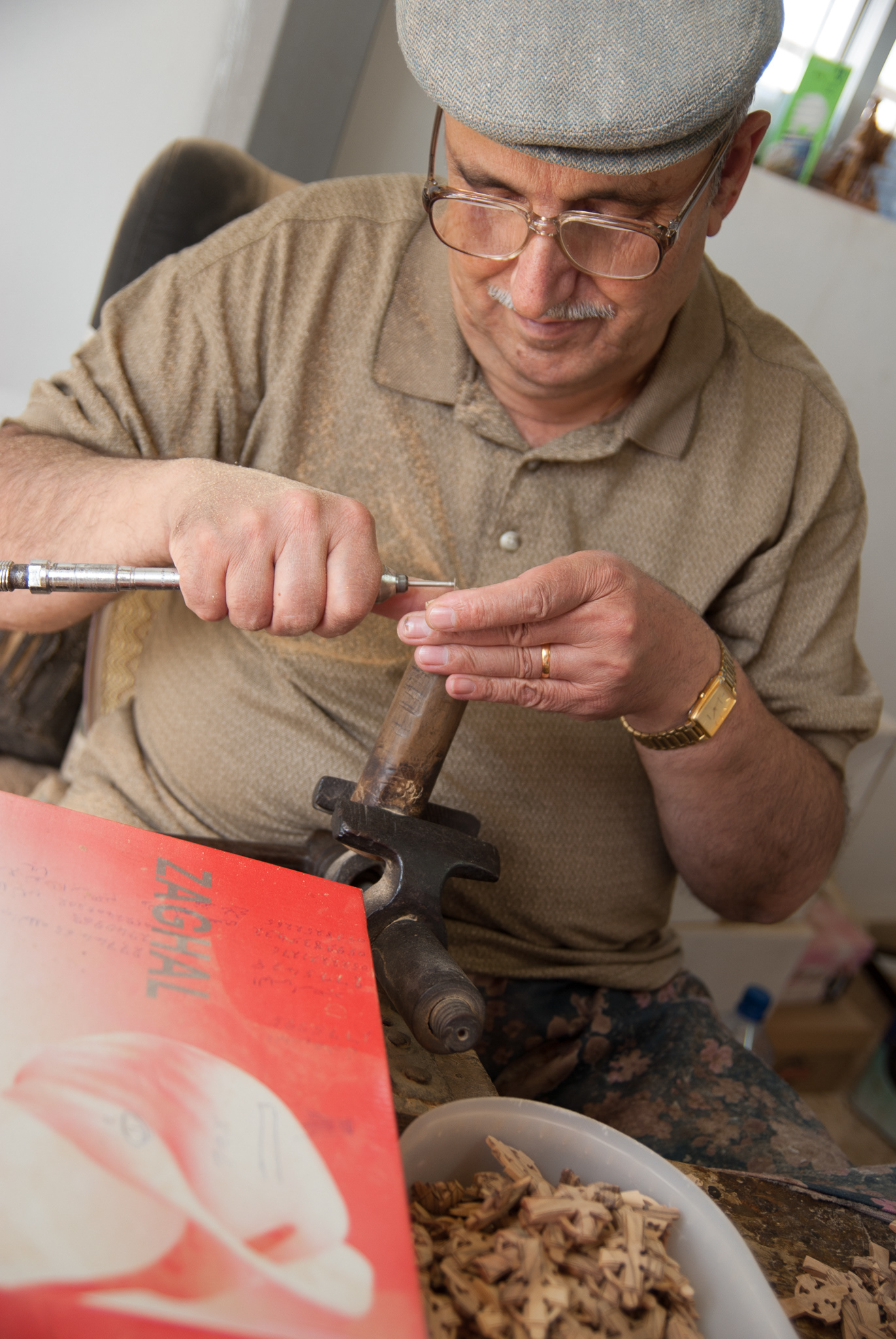 A woodworker caves olive wood crosses popular with tourists in Bethlehem.
