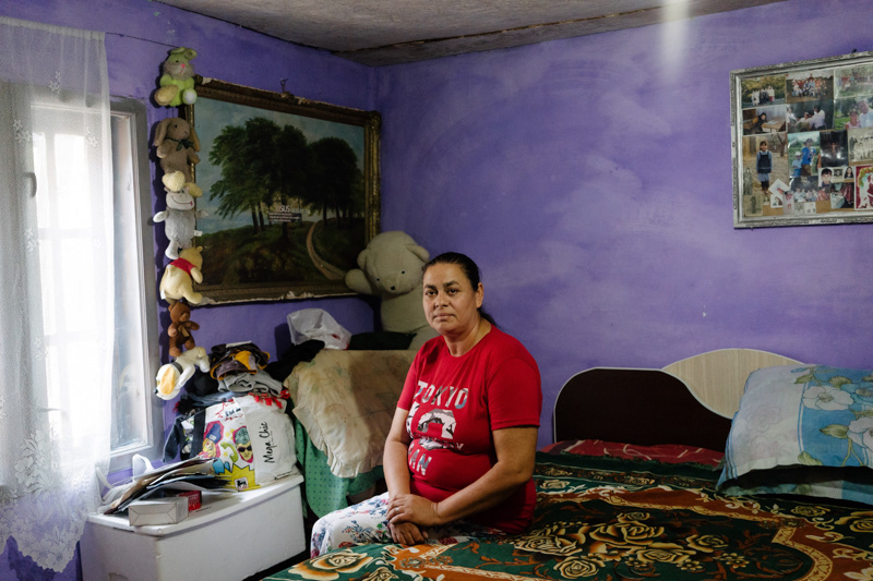 Nicoleta, 45. Her daughter was the victim of a local human trafficking network, and now has to stay with her aunt in a nearby village to take care of her disabled cousin. Nicoleta tends to the household together with her husband. Gaujani commune, Giurgiu county.