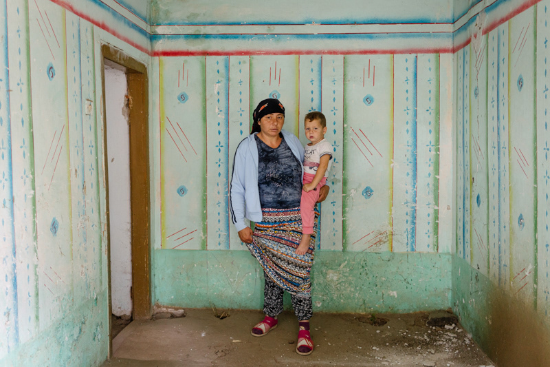 Mariana, 34. The photo was taken in what is left of their old house, out of which they had to move, because of its precarious state and risk of collapsing. Ocolna village, Dolj county