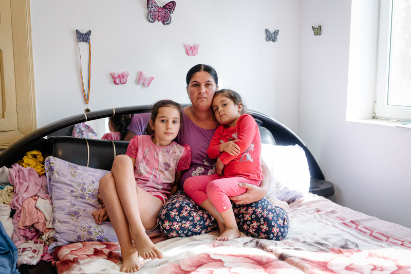 Gabriela, 37, and her two daughters. Gabriela met her husband during the years she spent working abroad. Amarasti commune, Dolj county.