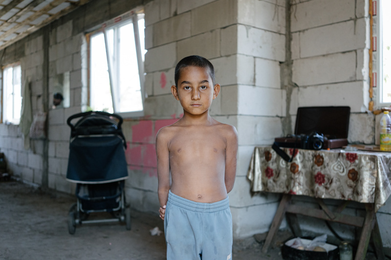 Irina’s nephew, in the improvised kitchen from their home, which is still under construction. Pietrisu village, Giurgiu county.