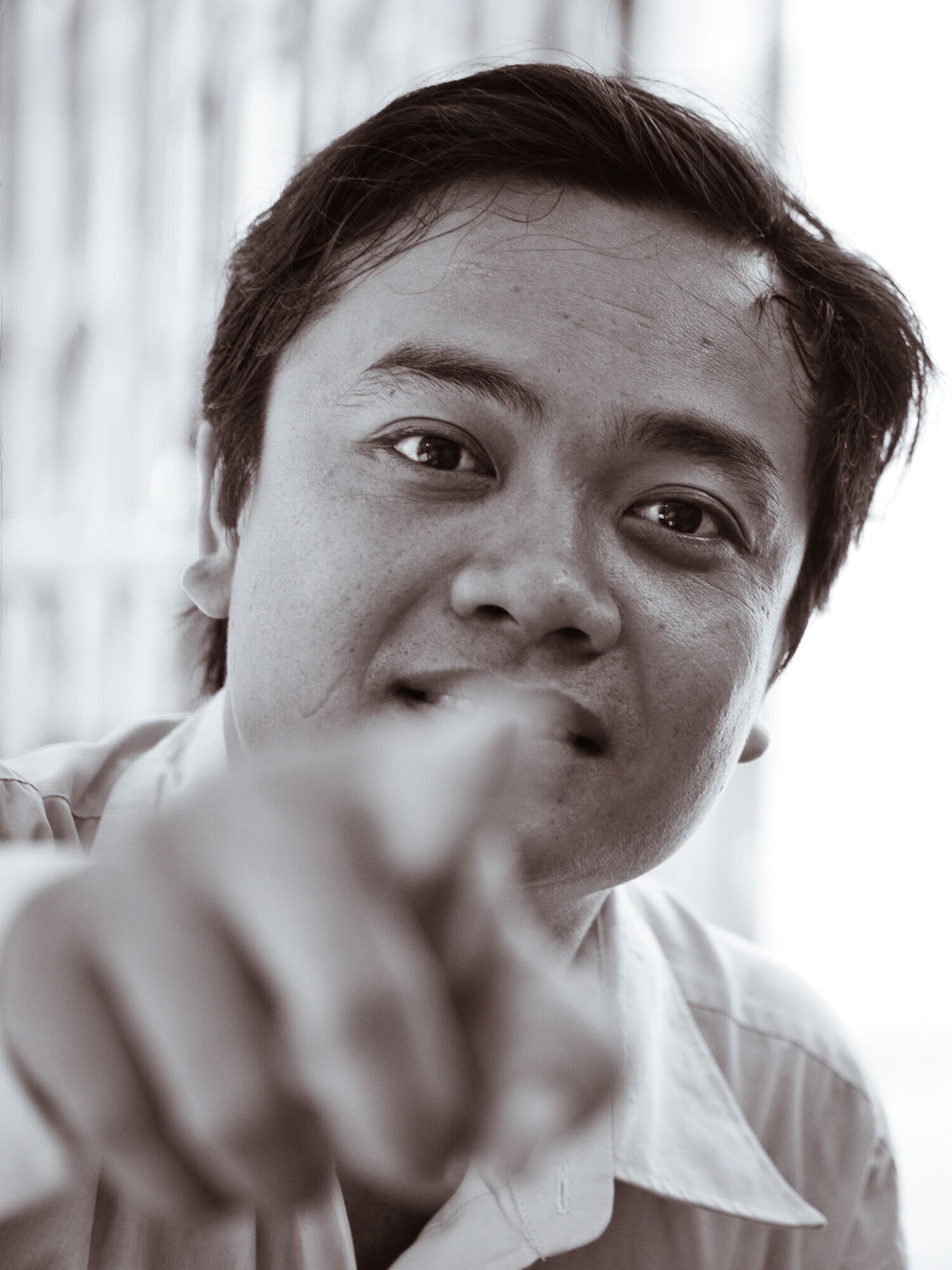 This man sat down next to me, and asked me how much my camera was.  And then the lens.  Vietnamese can be direct…  In this shot, he is actually telling me to pop up my flash (he's pointing to the release button.)  We had a very nice chat, actually.