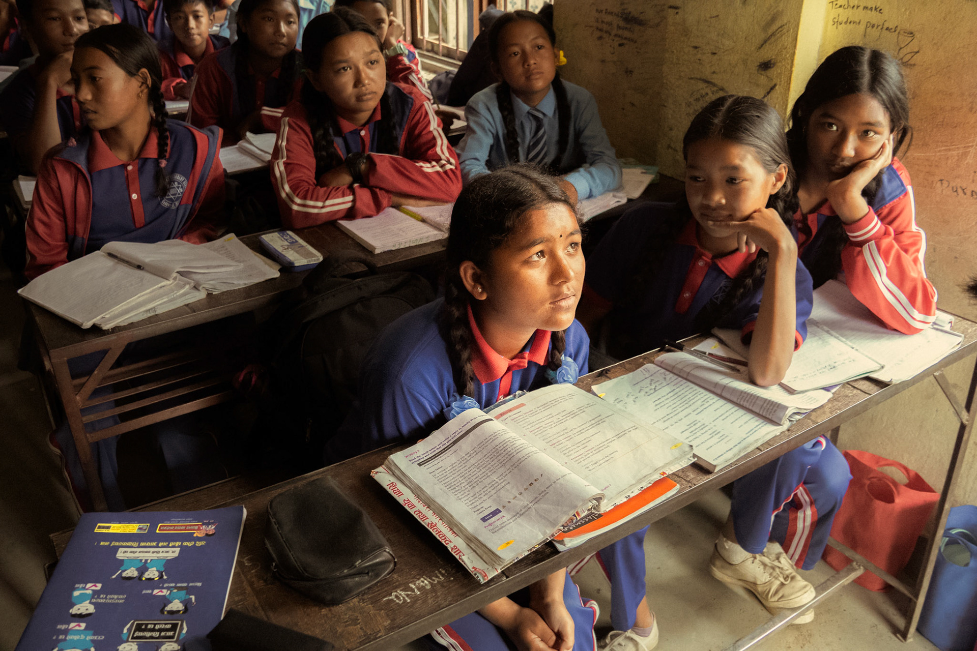 A student in the Shree Buddha school telling us her name and her likes. Her friends look on with support.