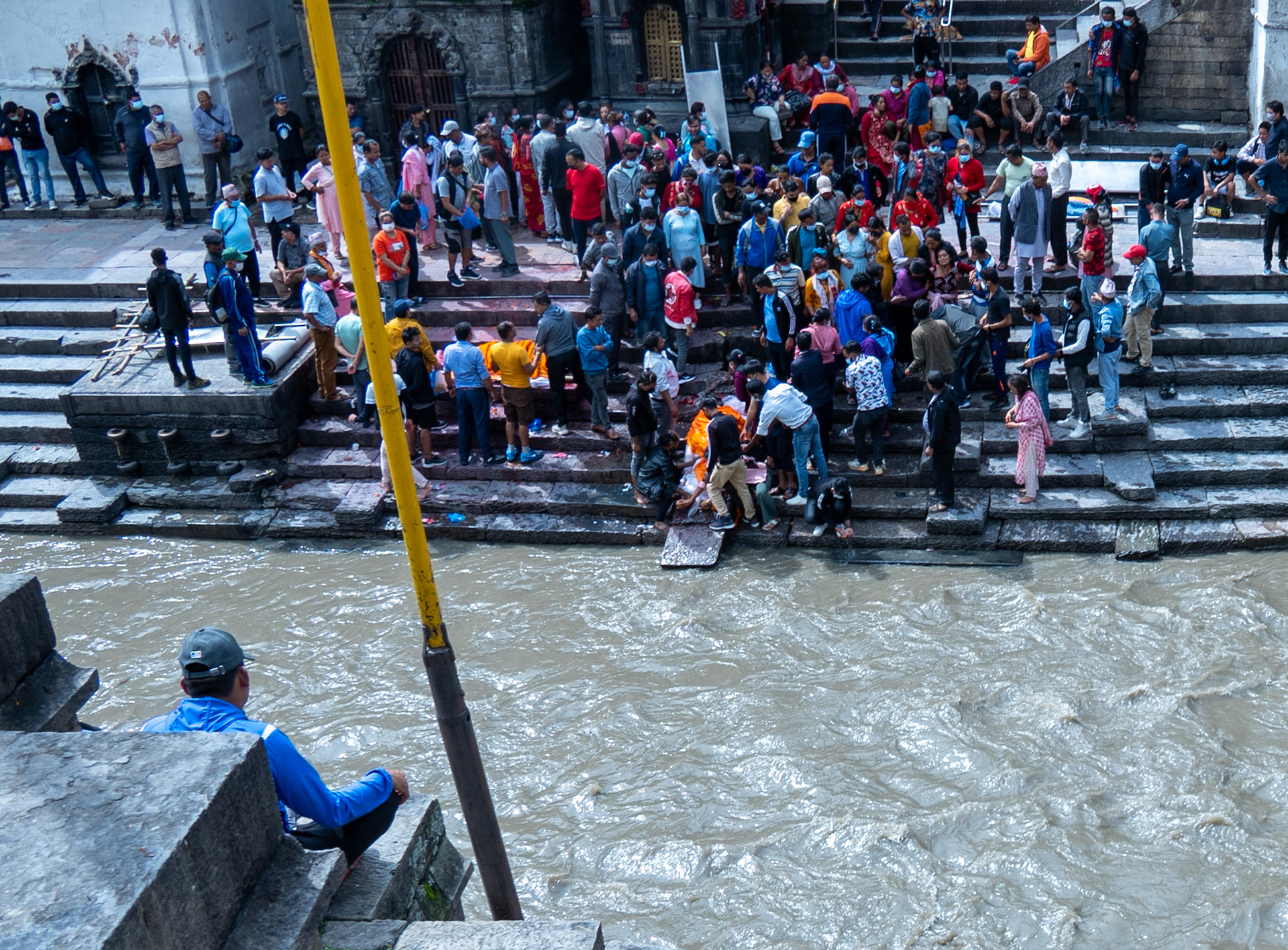 Despite the scarcity, water has deep ties to the Nepali culture. Here, a family performs funeral rites on the river near the temple.
