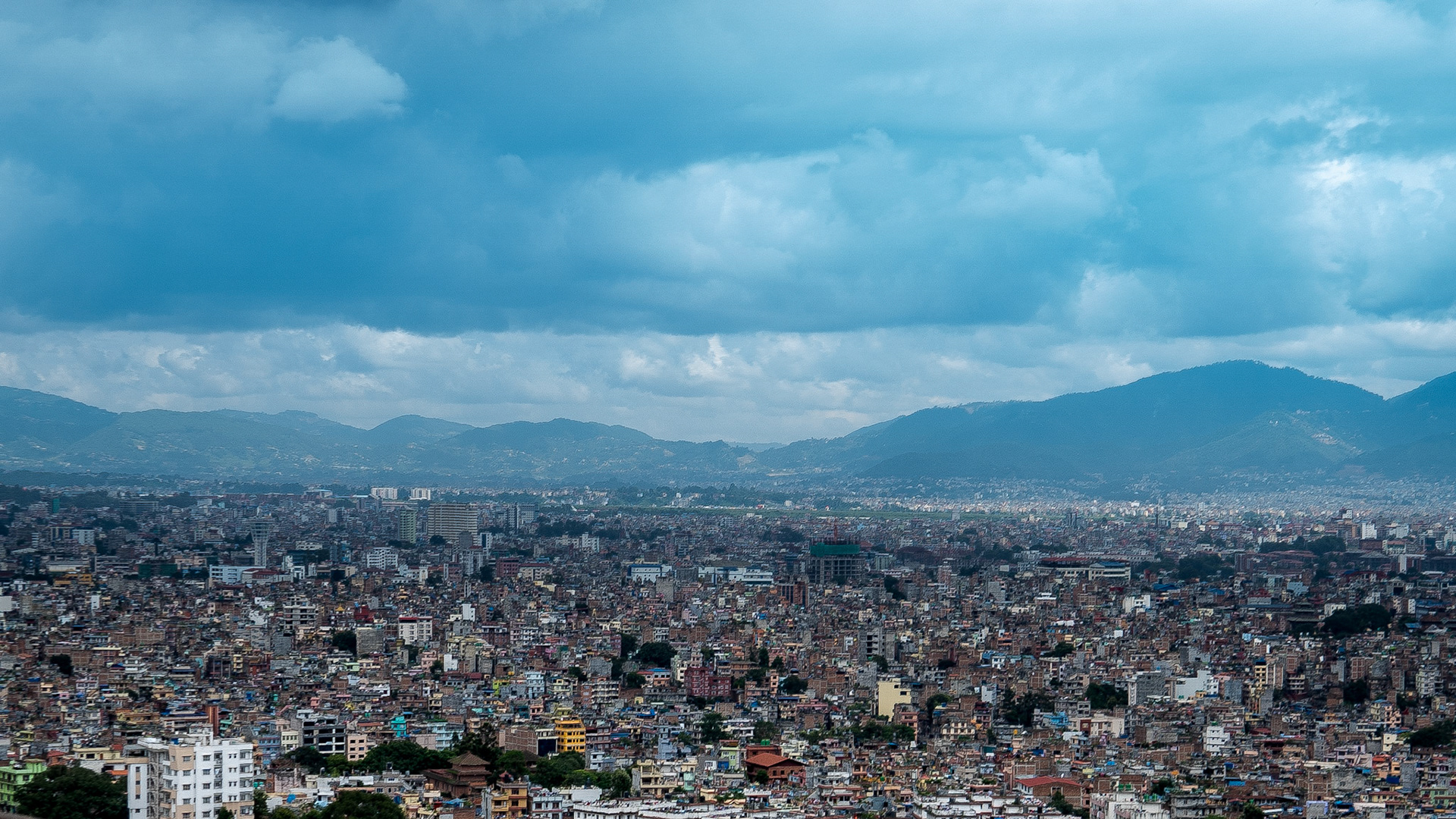 Nepal's population of 31 million highlighted by the urban sprawl that stretches to the mountains.
