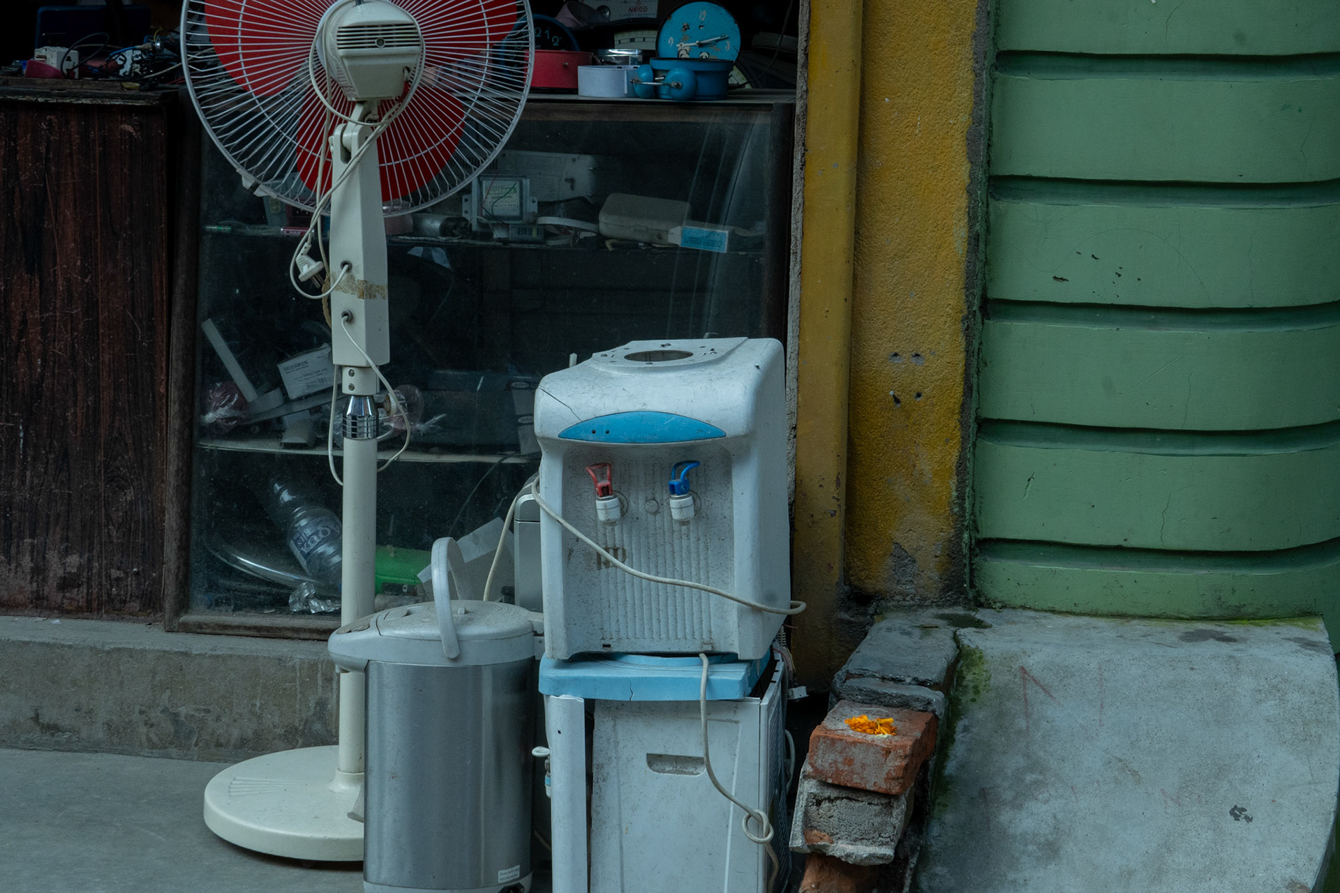 An abadoned water filtration system on the side of the road, likely from wear and tear and amidst Nepal's water situations.
