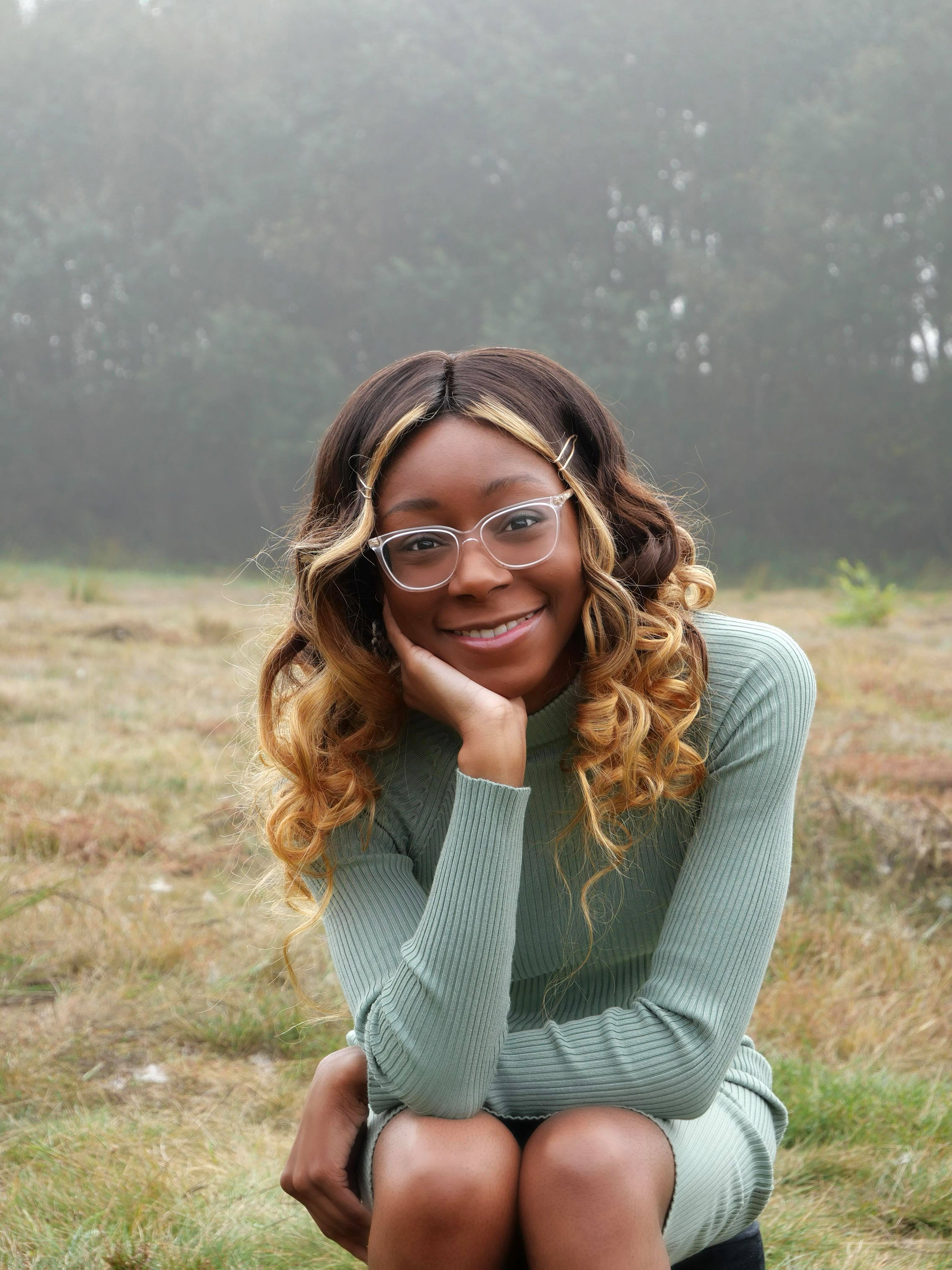 Photo of Lynette sitting, background of trees and fog