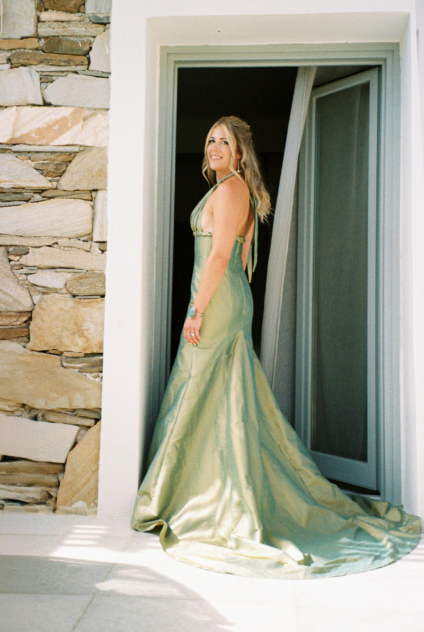 A grecian-inspired custom design for this bride getting married overseas. The dress is constructed from an iridescent silk taffeta woven in green and gold.