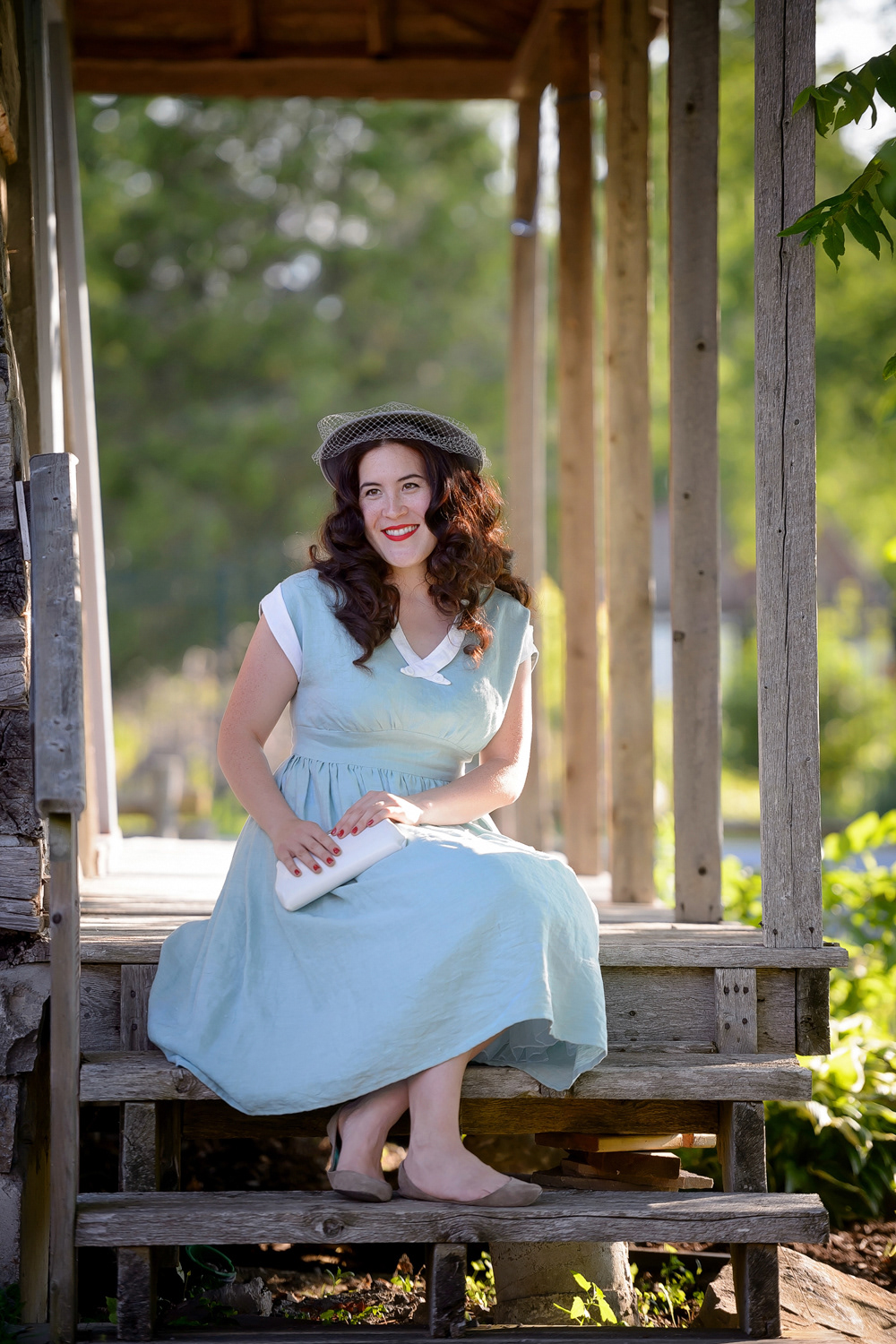 Early 50s Day Dress: Linen dress with gathered skirt, fitted waist and dropped shoulder sleeve. White linen detailing and decorative collar buttons complete the look.