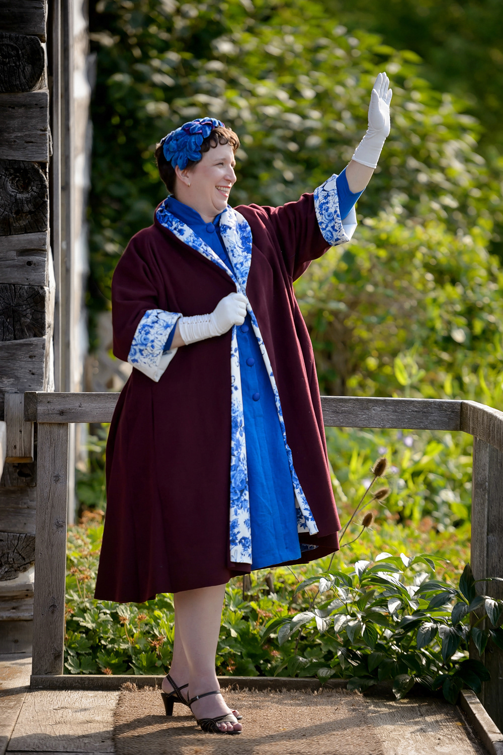 1950s Swing Coat and Dress: This purple wool swing coat is typical of the 1950s. It’s completed with a luxurious silk satin lining for a classic sophisticated look. A blue linen dress with a high neckline and pleated skirt pulls the whole outfit together.