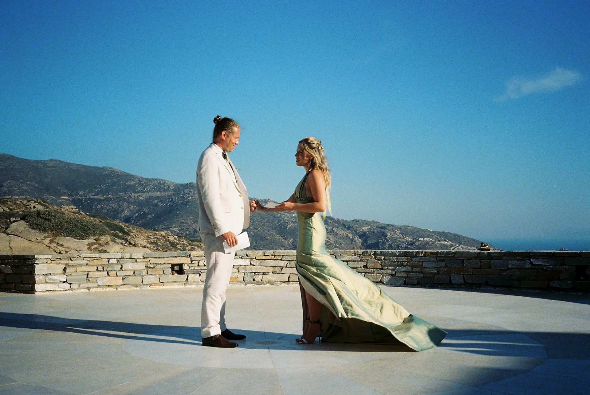 A grecian-inspired custom design for this bride getting married overseas. The dress is constructed from an iridescent silk taffeta woven in green and gold.