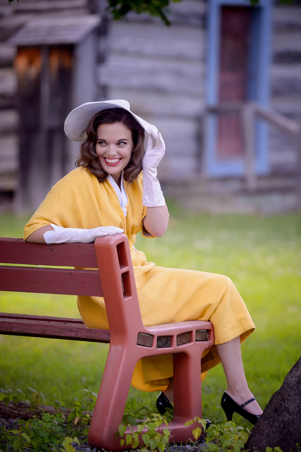 Late 50s Day Dress & Capelet: This yellow linen dress has a pencil skirt pleated at the waist and raglan sleeves, all capturing the iconic 1950s silhouette. The look is completed with a matching capelet and decorative waterfall detail in the skirt, color-blocked with white linen.