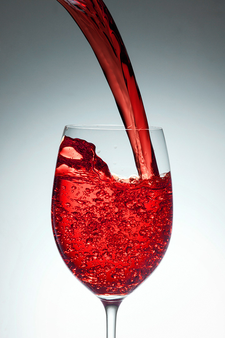 A high speed photograph of a beverage splashing into a glass. An introductory photo for a gallery on beverages and liquids by a Metro Manila based Food Photographer.