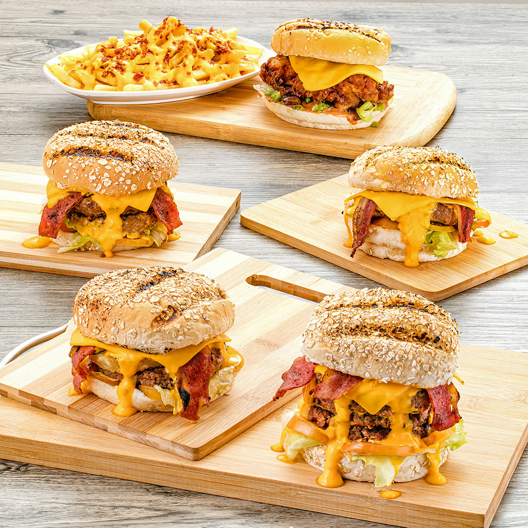 A sample of professional food photography featuring a collection of burgers and sandwiches. This serves as an introductiory image to a gallery of food photos of breads, burgers, and sandwiches.