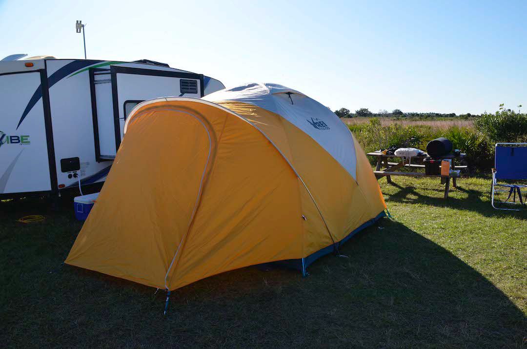 My giant REI BASECAMP 6 tent. You can stand up inside. 10' X 10' inside. Outer rainfly shell has large vestibules on each end, each has entry door.