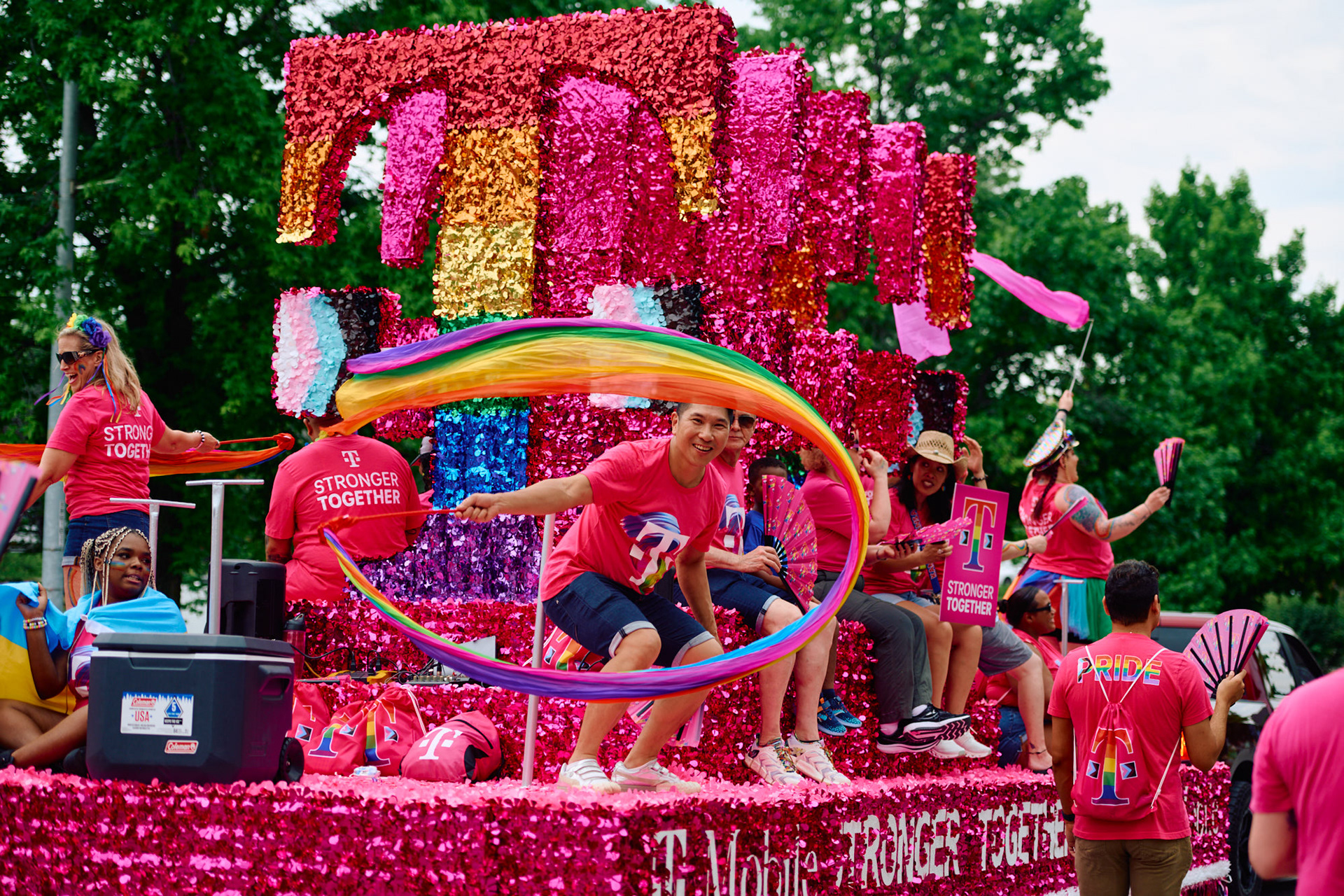 Close-up of the Pride float with attendees in branded shirts