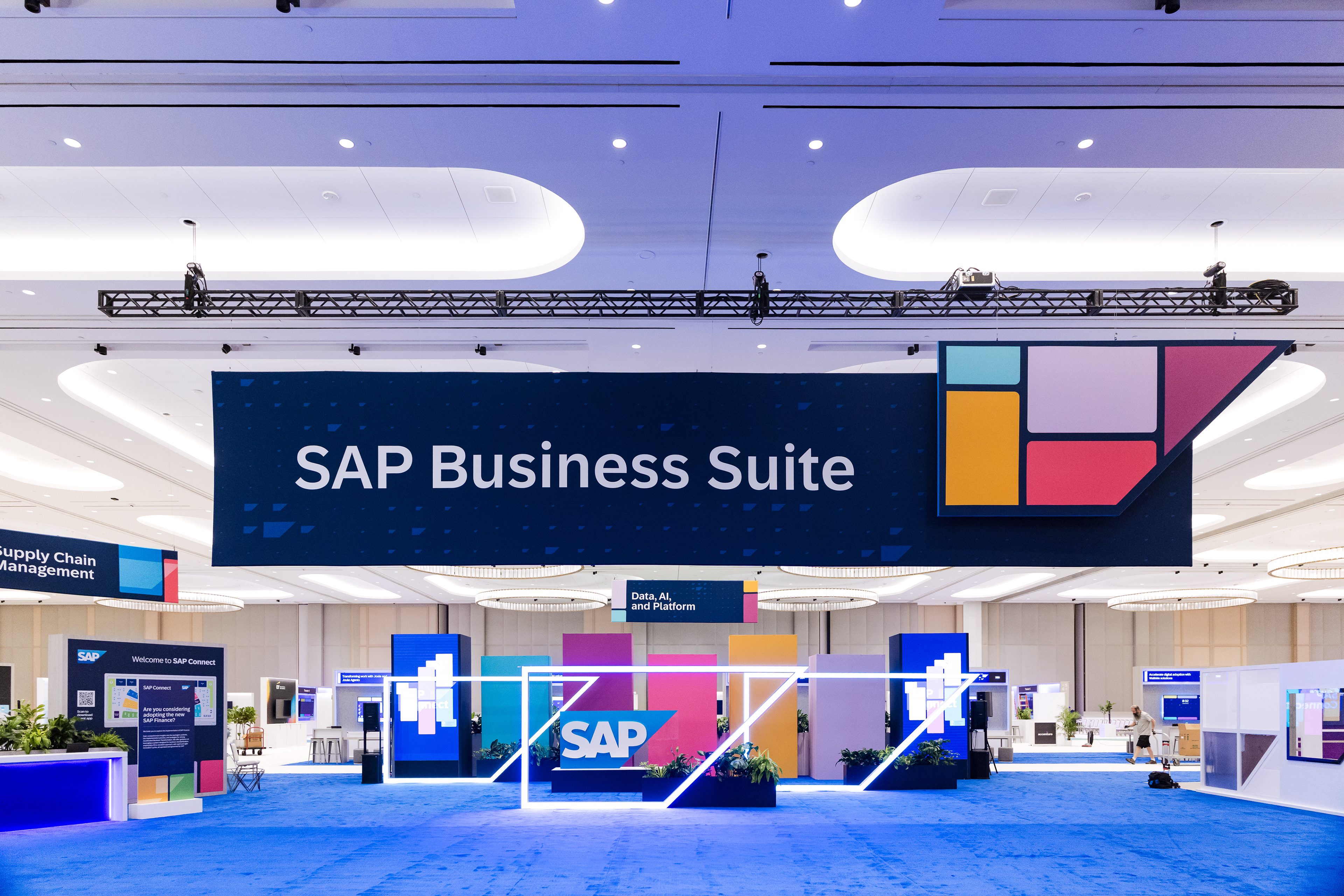 Wide venue shot of the SAP Business Suite banner over the show floor