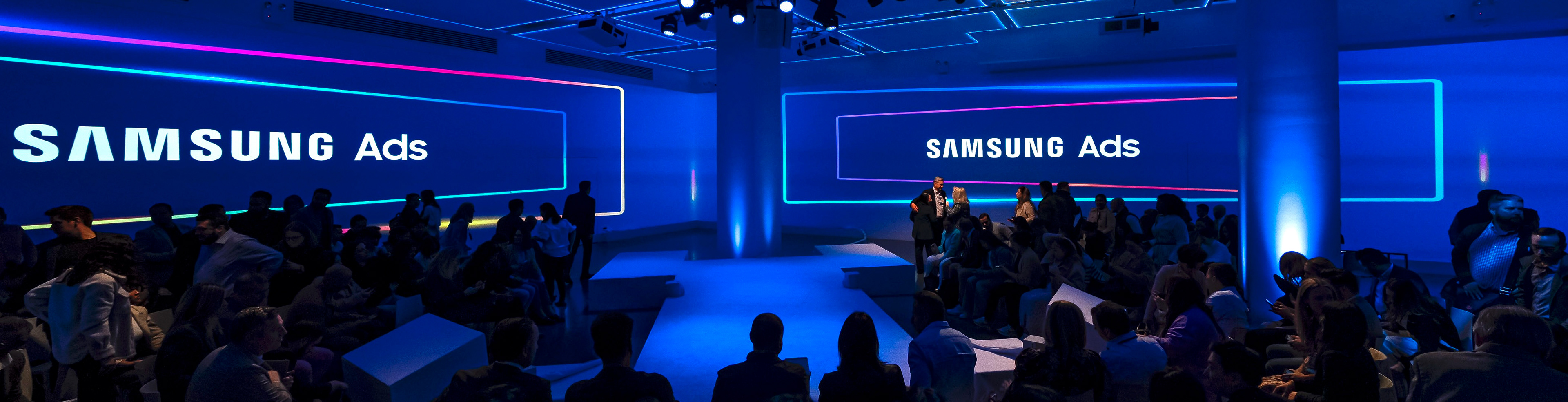 Samsung Ads NewFront stage with glowing blue and pink neon backdrop