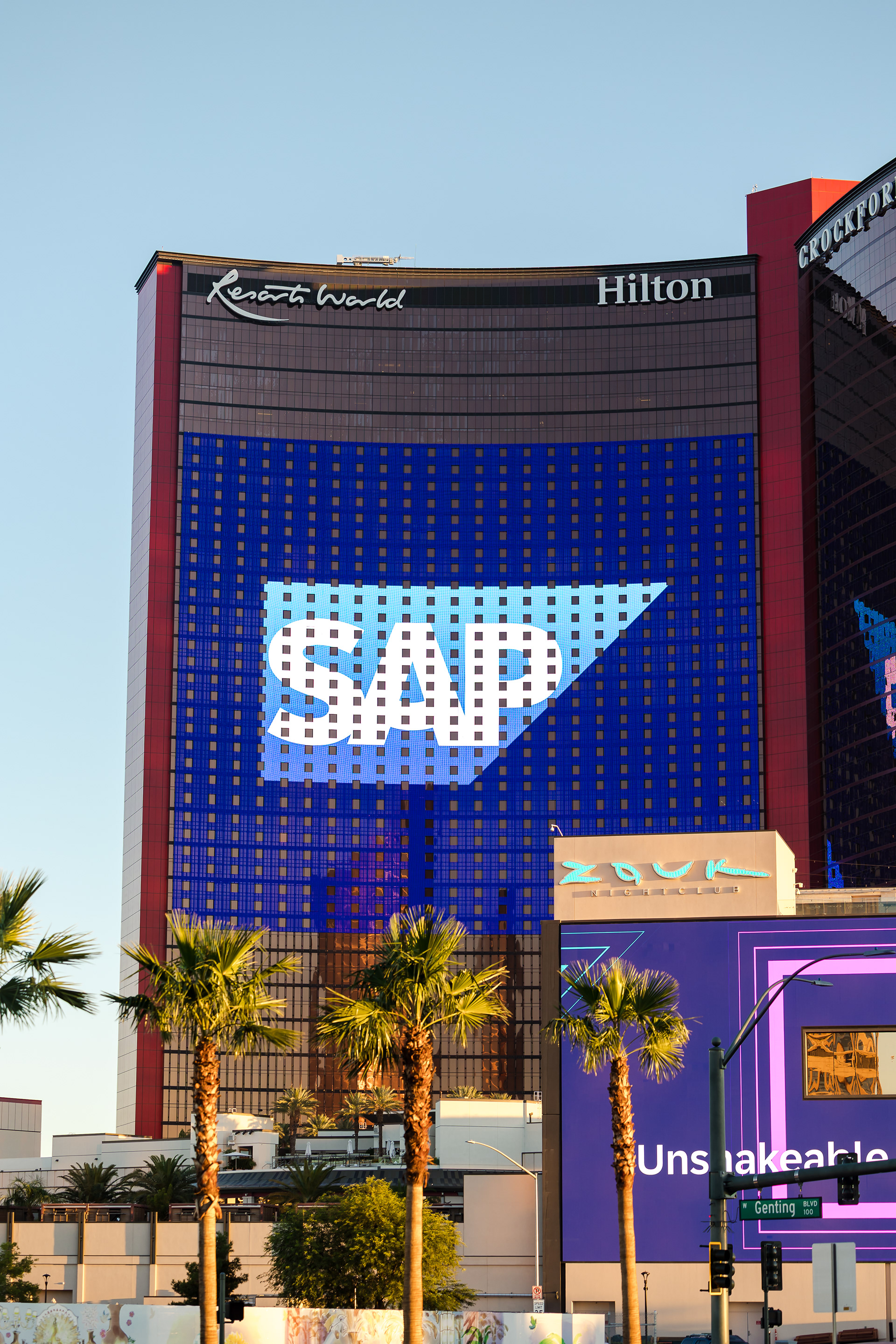 Illuminated SAP logo on the Resorts World Las Vegas building facade