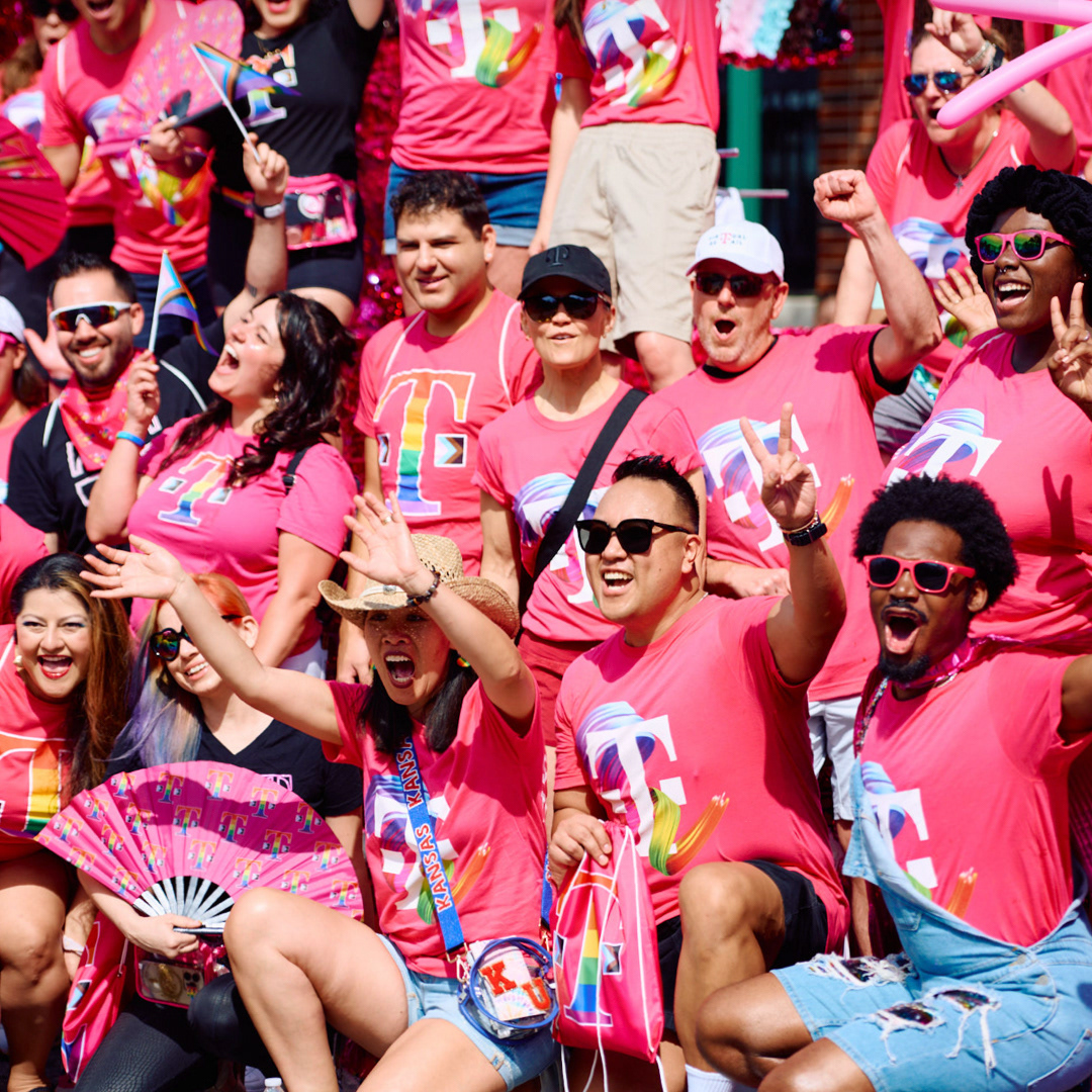 Pride parade attendees in pink T-Mobile shirts