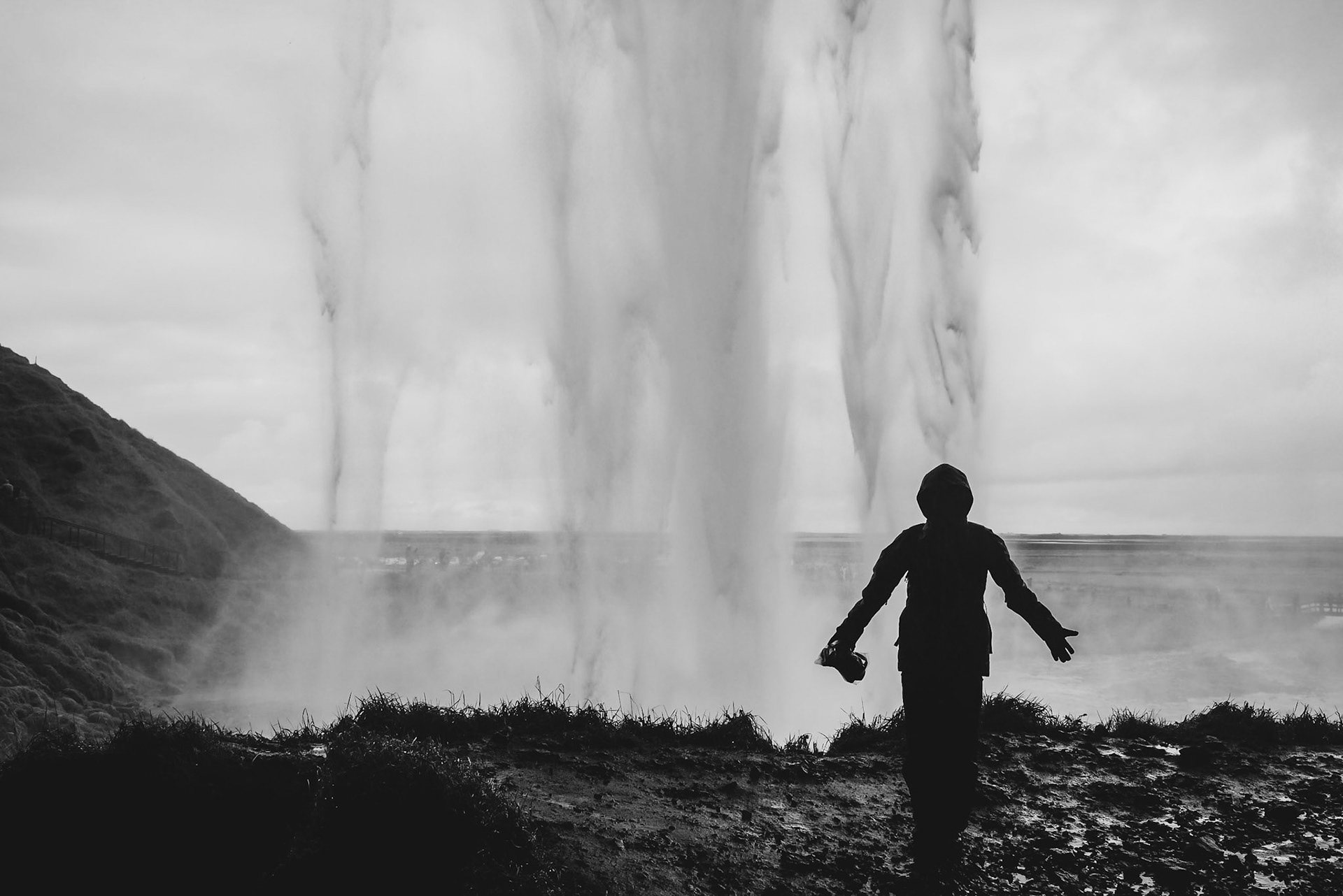 Iceland is filled waterfalls for days. During a 14-day photo roadtrip around Iceland, this is one of my favourite shots I took because it was a challenging photo to take, trying keep my camera dry and away from the water sprays from the waterfall long enough to take this silhouette photo of my friend behind the falls. This photo captures the wild and wet adventure I had around Iceland.
