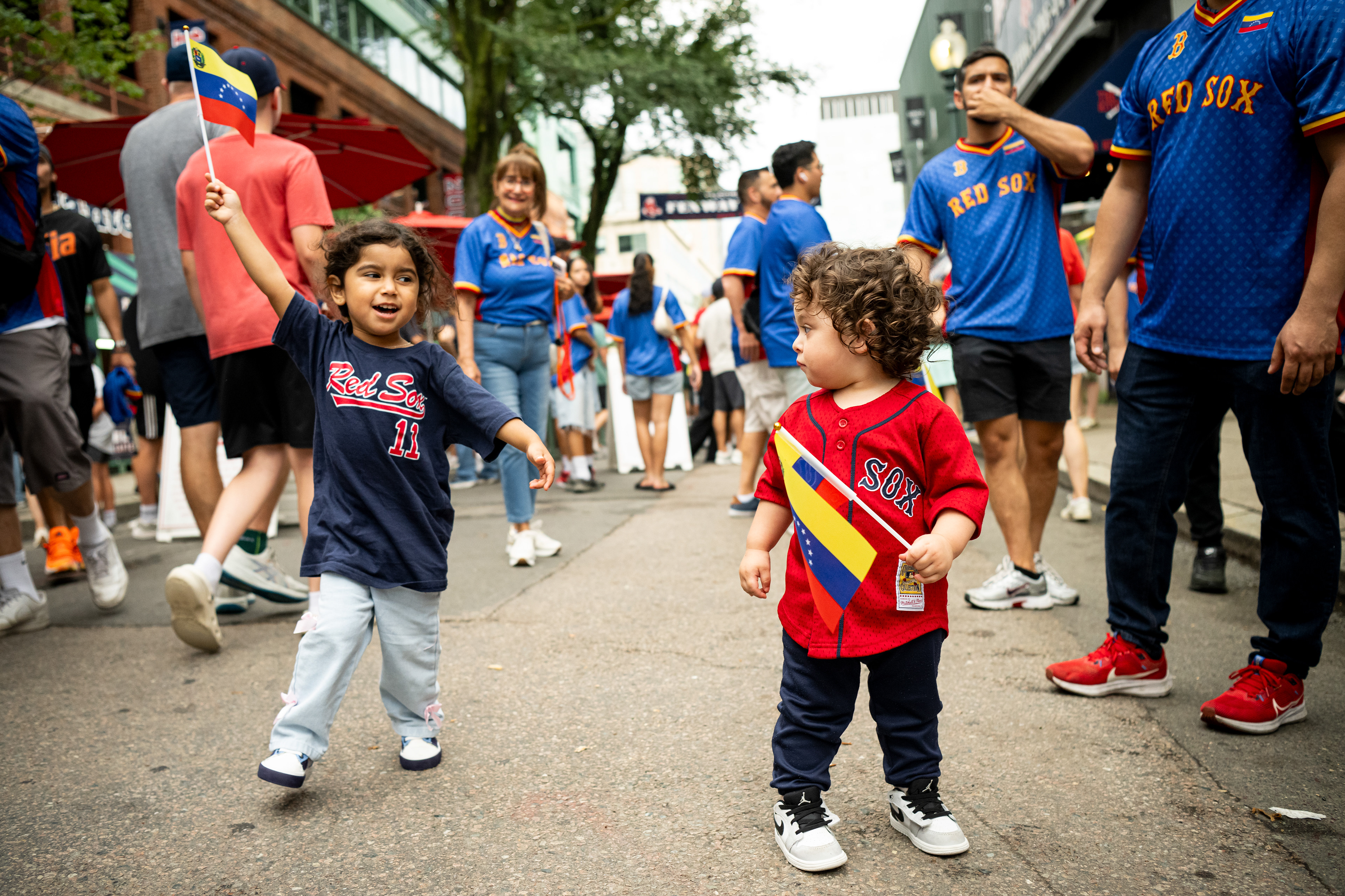 July 22, 2026, Boston, MA: Young fans wave Venezuelan flags on Jersey Street prior to game two of a doubleheader between the Baltimore Orioles and the Boston Red Sox at Fenway Park in Boston, Massachusetts Wednesday, July 22, 2026. (Photo by Aiden Shertzer/Boston Red Sox)