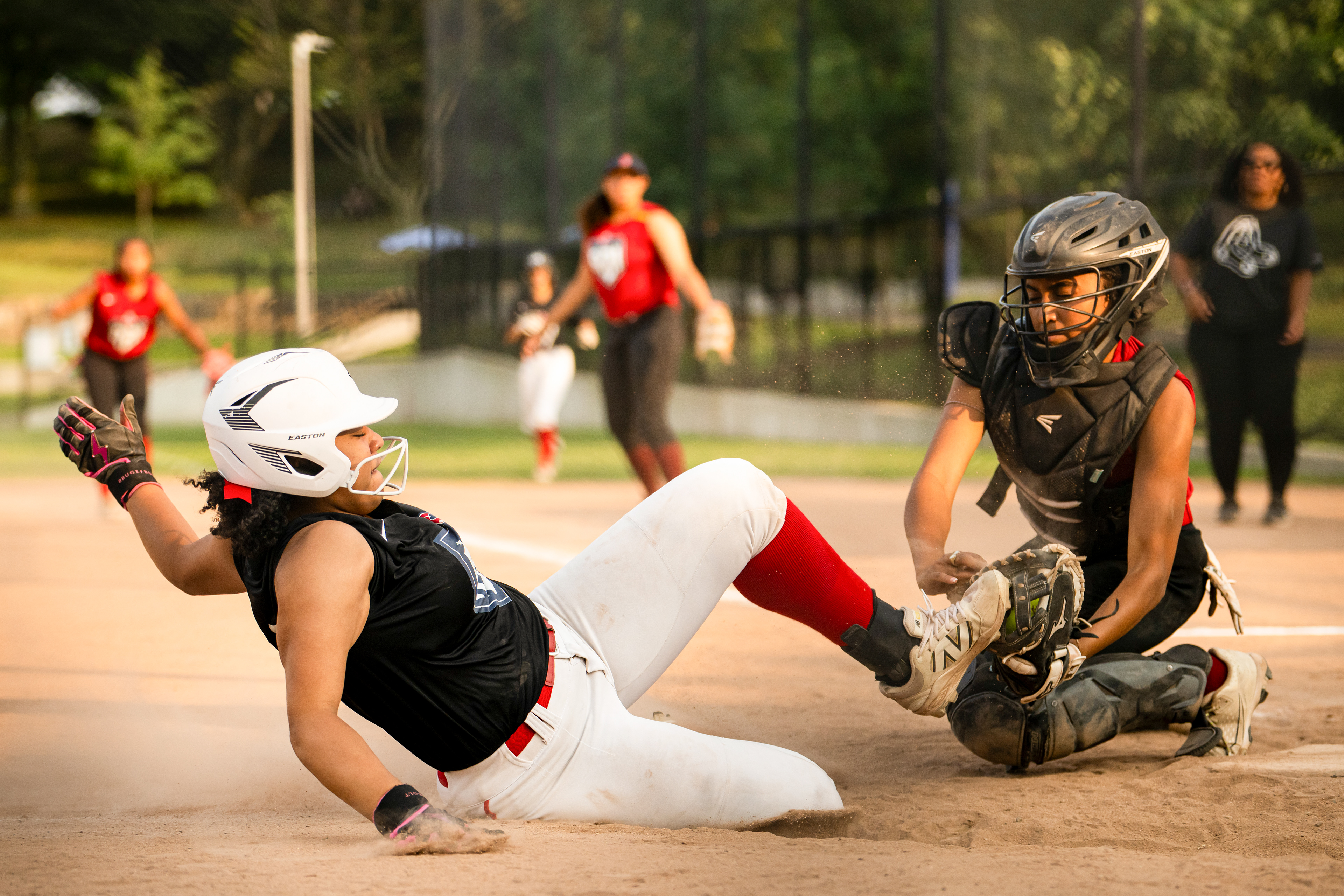 August 12, 2026, Boston, MA: A Roxbury Astros player slides into home plate ahead of the tag from a Fenway Phillies player during the Red Sox Foundation RBI Softball Championship at Malcolm X Park in Boston, Massachusetts Wednesday, August 12, 2026. (Photo by Aiden Shertzer/Boston Red Sox)