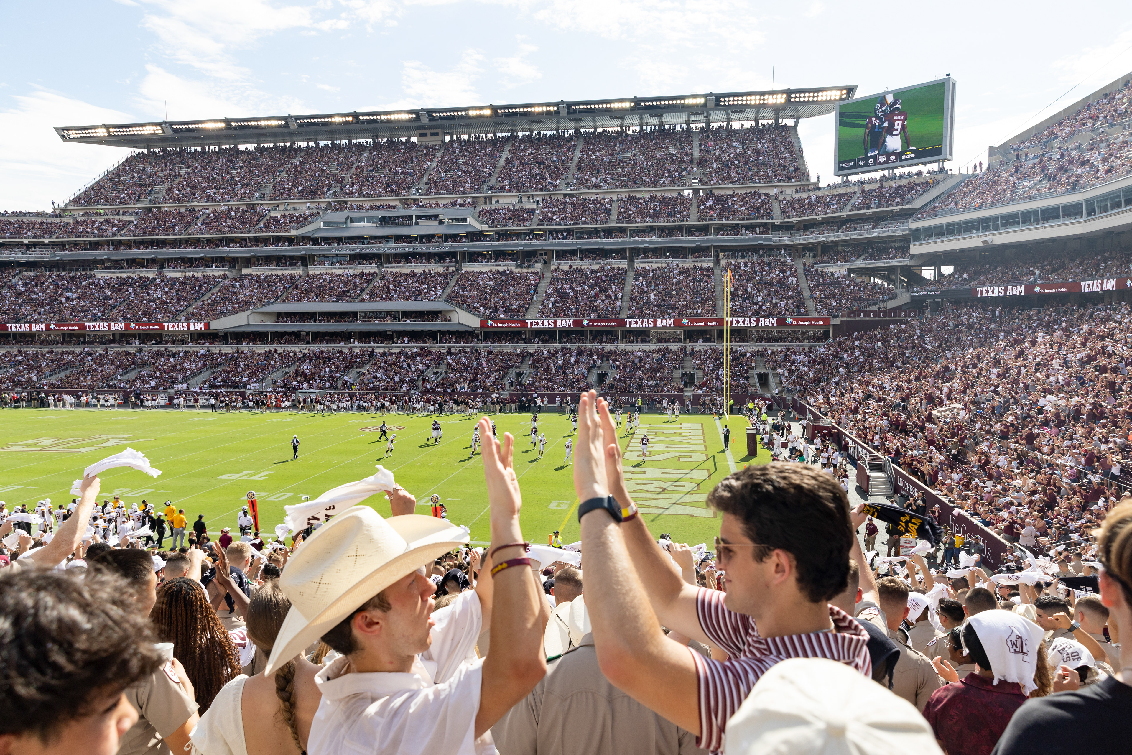 COLLEGE STATION, TX - September 16, 2023 - Fans high five after a touchdown during a game between the ULM Warhawks and the Texas A&M Aggies at Kyle Field in College Station, TX. Photo By Aiden Shertzer/Texas A&M Athletics