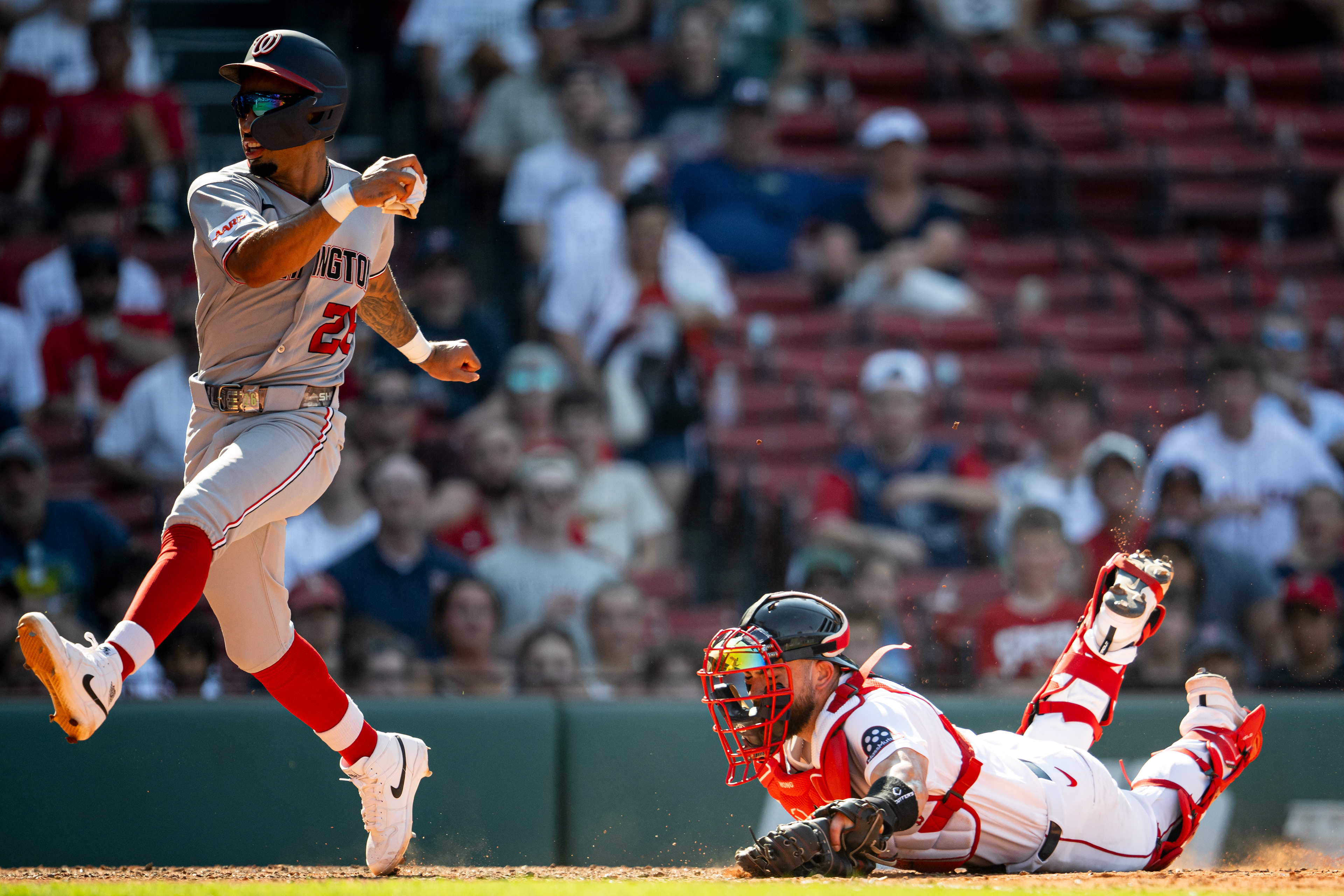 July 1, 2026, Boston, MA: Nasim Nuñez #26 of the Washington Nationals avoids a tag from Connor Wong #12 of the Boston Red Sox at home plate during the ninth inning of a game at Fenway Park in Boston, Massachusetts Wednesday, July 1, 2026. (Photo by Aiden Shertzer/Boston Red Sox)