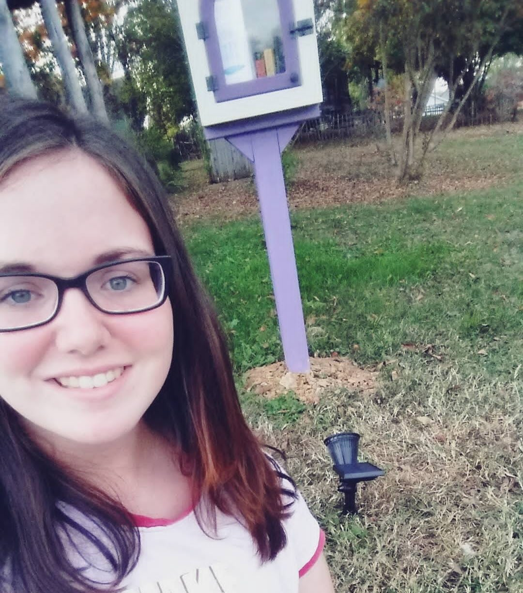 Placing solar light by Little Free Library